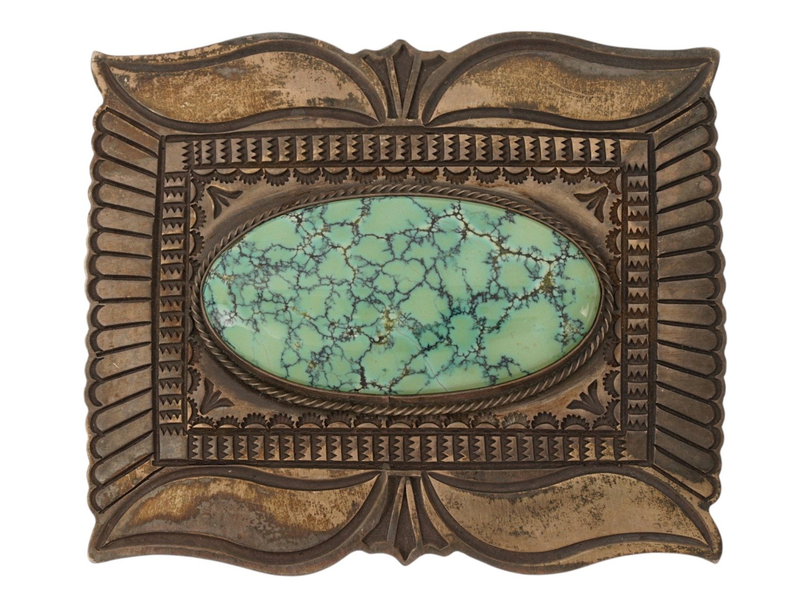 STERLING SILVER AND TURQUOISE BELT BUCKLE MARKED: A Sterling Silver belt buckle. The ware features a central oval Tibetan turquoise cabochon. The plate is decorated with intricate geometric patterns, including radiating sunburst lines and stylized fo
