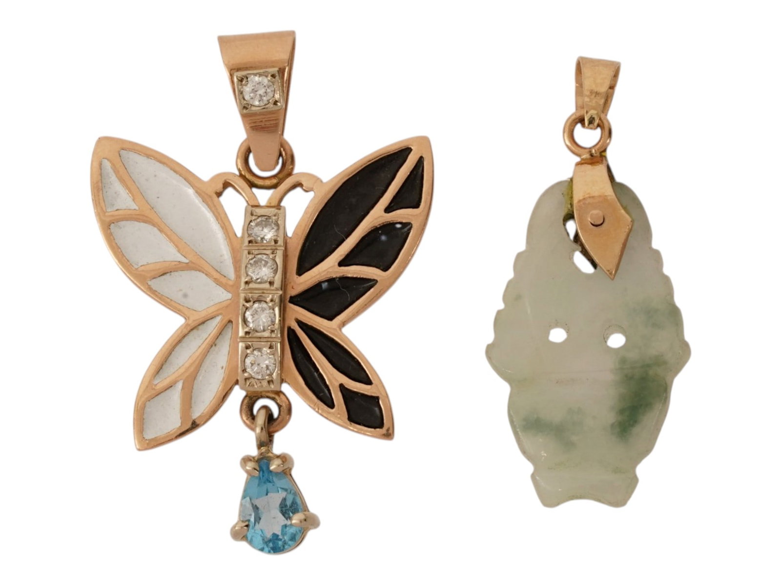 PAIR OF VINTAGE 18K AND 14K GOLD PENDANTS: A pair of vintage yellow gold pendants. First. A carved jade charm with 18K gold fittings. Second. 14K gold butterfly pendant garnished with enamel and crystals. Each piece is marked on the fitting