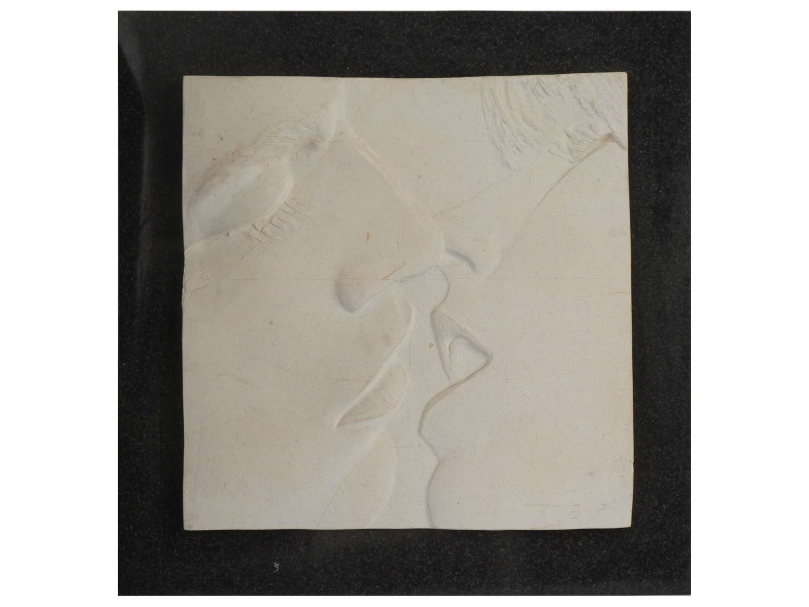AMERICAN PLASTER THE KISS BAS RELIEF BY DAVID FISHER: A vintage plaster bas-relief titled The Kiss by American artist David Fisher, 1990. The artwork depicts two lovers approaching each other in a kiss. Signed by Fisher and dated 1990 on the frame. Ameri