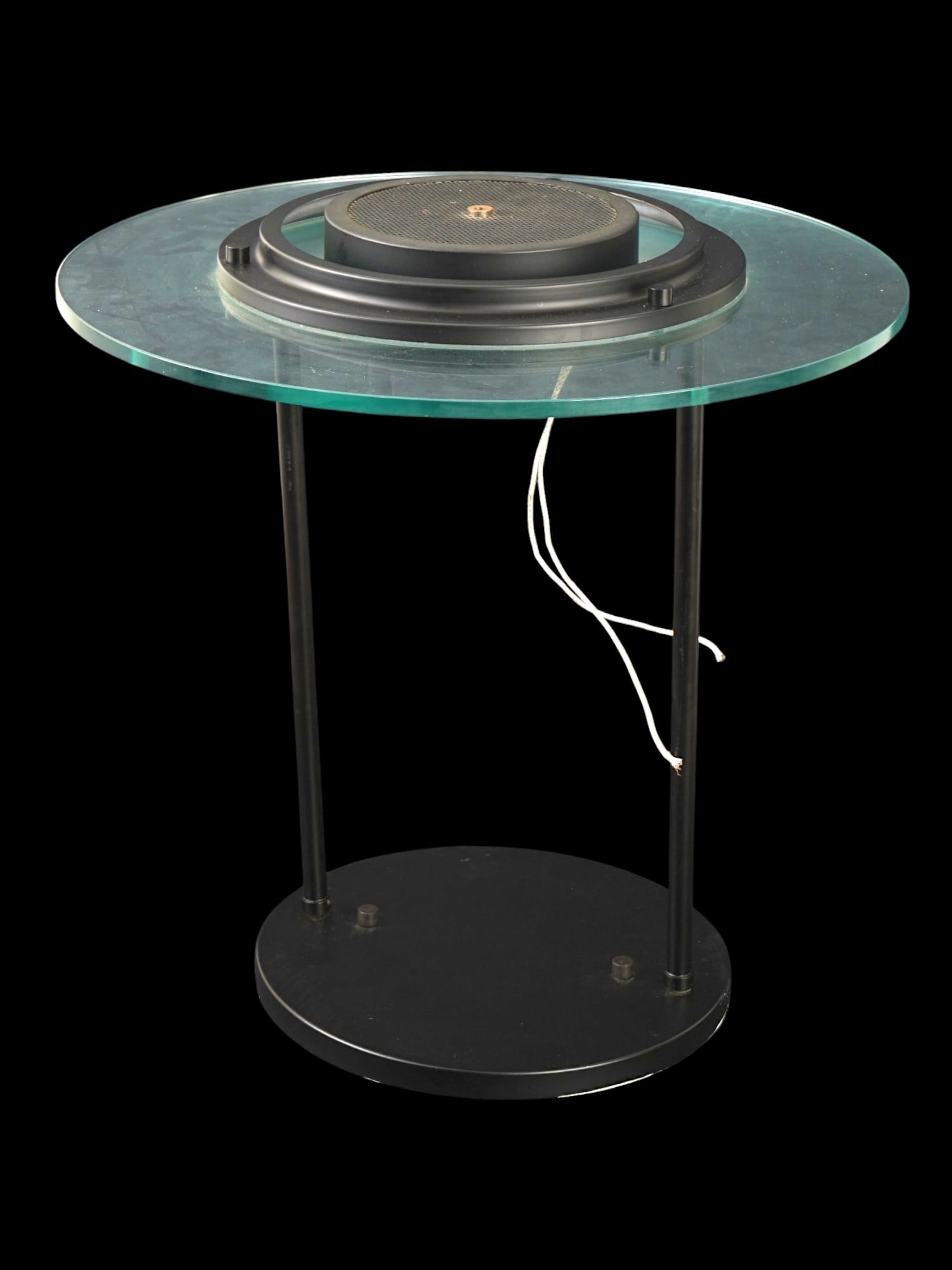 VINTAGE ROBERT SONNEMAN STYLE SATURN TABLE LAMP: A vintage Robert Sonneman style Saturn table lamp. Ca. 1980s. The lamp features a thick circular glass top suspended above a black metal cylindrical base by two slender tubular supports. Centered with