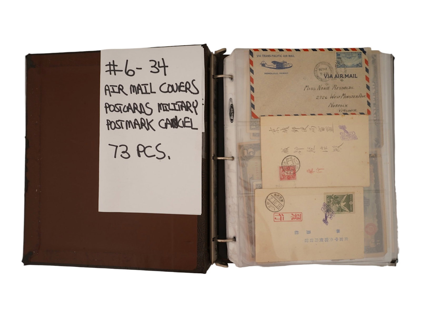 VINTAGE MILITARY POSTAL HISTORY COVERS CURRENCY ALBUM: A collection of 73 vintage postal history covers, including U.S. Trans-Pacific Air Mail, international correspondence, and military postal items. The lot also includes Japanese occupation currency fro