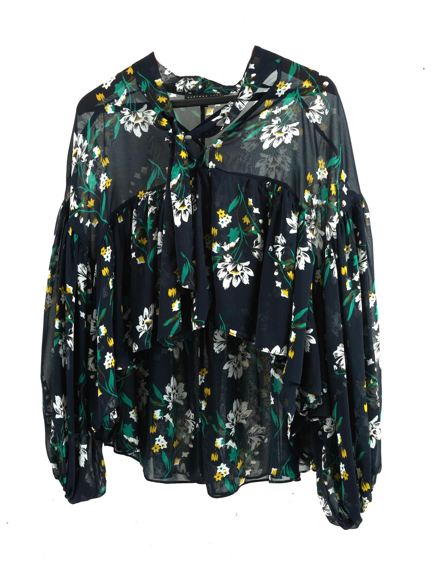 ENDLESS ROSE WOMENS BLACK FLORAL PRINT BLOUSE: A womens blouse by Endless Rose, an American brand based in Los Angeles in 2012. Black chiffon with white and green floral print. Loose fit with ruffles, long puff sleeves, bow tied at the front. Wome