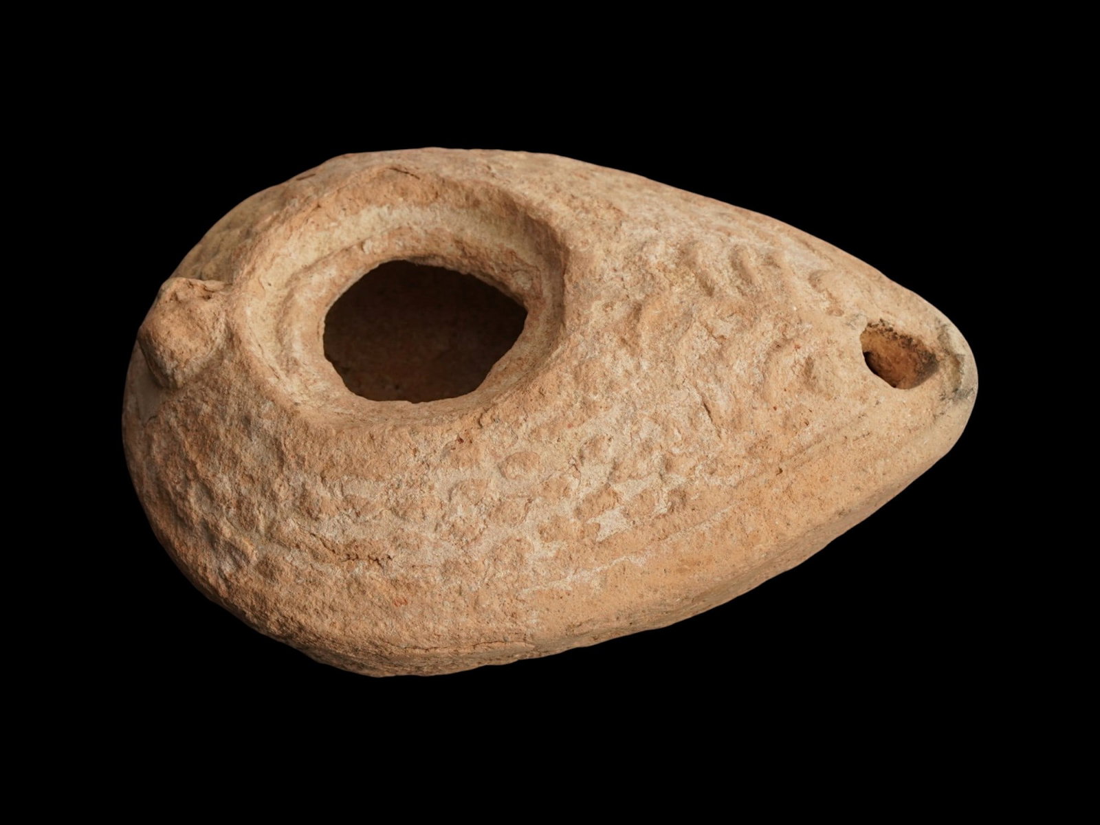 ANCIENT JUDAICA MENORAH TERRACOTTA OIL LAMP 300 400 AD: An ancient Roman Holy Land Judaica terracotta pottery oil lamp dating from 300 to 400 AD. The ware is decorated with a Menorah motif on the spout. Reflects the artistic and spiritual culture of the la