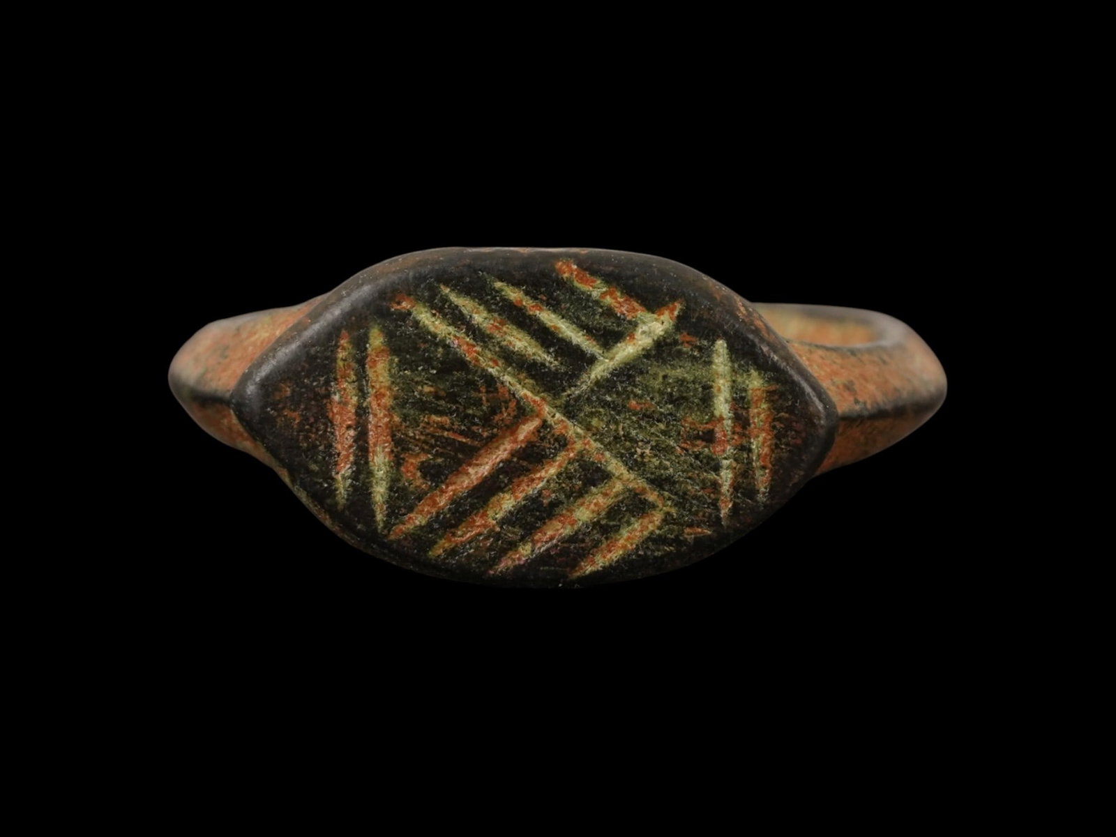 ANCIENT ROMAN BRONZE SIGNET RING AGAINST EVIL EYE: An Ancient Roman bronze signet ring. Imperial Rome era, ca. 100 to 300 AD. The crown is etched in a cross pattern, indicating that the piece served as an amulet against evil eye. Historical Relics And