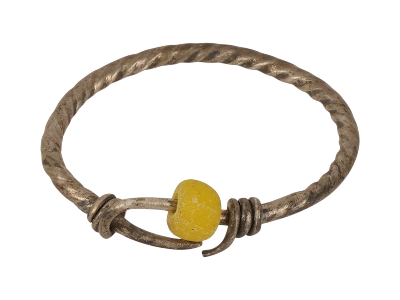 ANCIENT ROMAN SILVER RING WITH A GLASS BEAD: An ancient Roman silver ring with a glass bead, dating from circa 100 to 300 AD. The silver ring features a simple ancient construction with a decorative glass bead element. Ancient Roman Silver Jewel