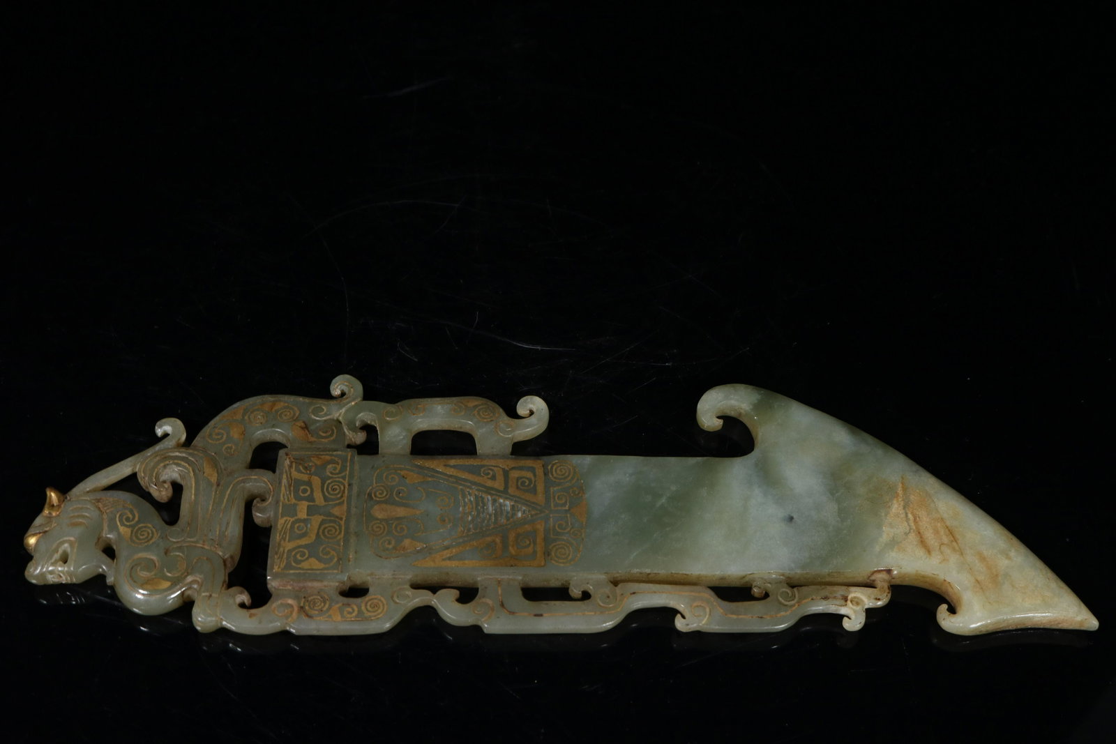 A jade painted gold 'unicorn' pendant: A jade painted gold 'unicorn' pendant Chinese Han Dynasty Size:26cmx7.6cmx0.9cm Weight:235g