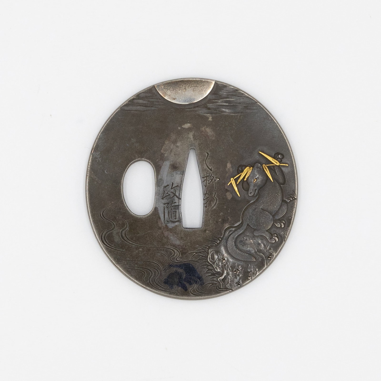 19th Century Tsuba depicting Inari Fox, Signed Masayuki: Tsuba depicting Inari Fox Silver, Shakudo, and Copper Inlay Signed: Otsuryuken Masayuki Date: 19th century Size: 6.9 x 6.6 x 0.4 cm, (C) 2.5 x 0.7 cm Condition: Some discoloration due to age. Ref: JG0