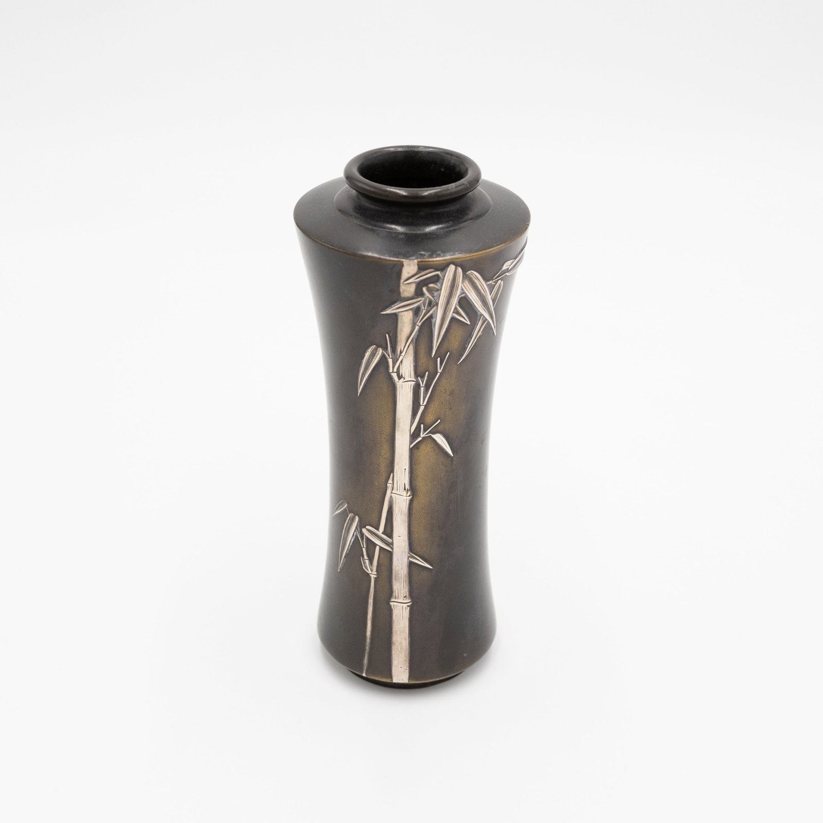 Japanese Silver-overlaid Bronze Vase, Bamboo Grove Design: Japanese Silver-overlaid Bronze Vase Decorated with a Bamboo Grove Date: Meiji Era (1868-1912) Size: (H) 18.1 x (W) 7.2 x (D) 7.2 cm Condition: Good for age. Ref: JG0925EA01