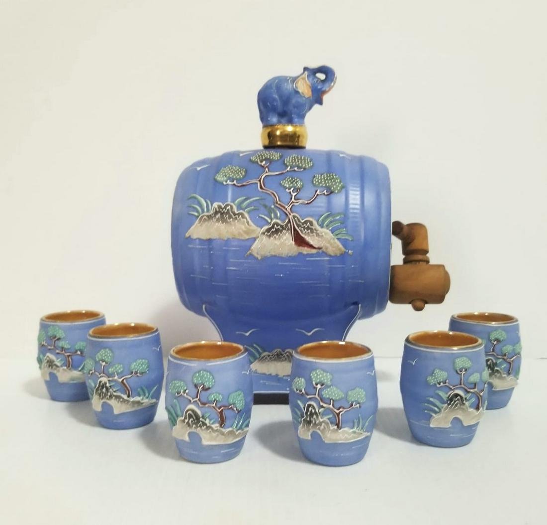 Vintage Hinode Japan Barrel Moriage Sake Cups: Beautiful ceramic hand painted Hinode Japan Moriage sake set 6 cups, it has an elephant stopper, blue color Bonsai, hand painted, wood in the barrel, barrel: 6 3/4 x 6 x 4 3/8 inches, cup 2 x 1 5/8 in