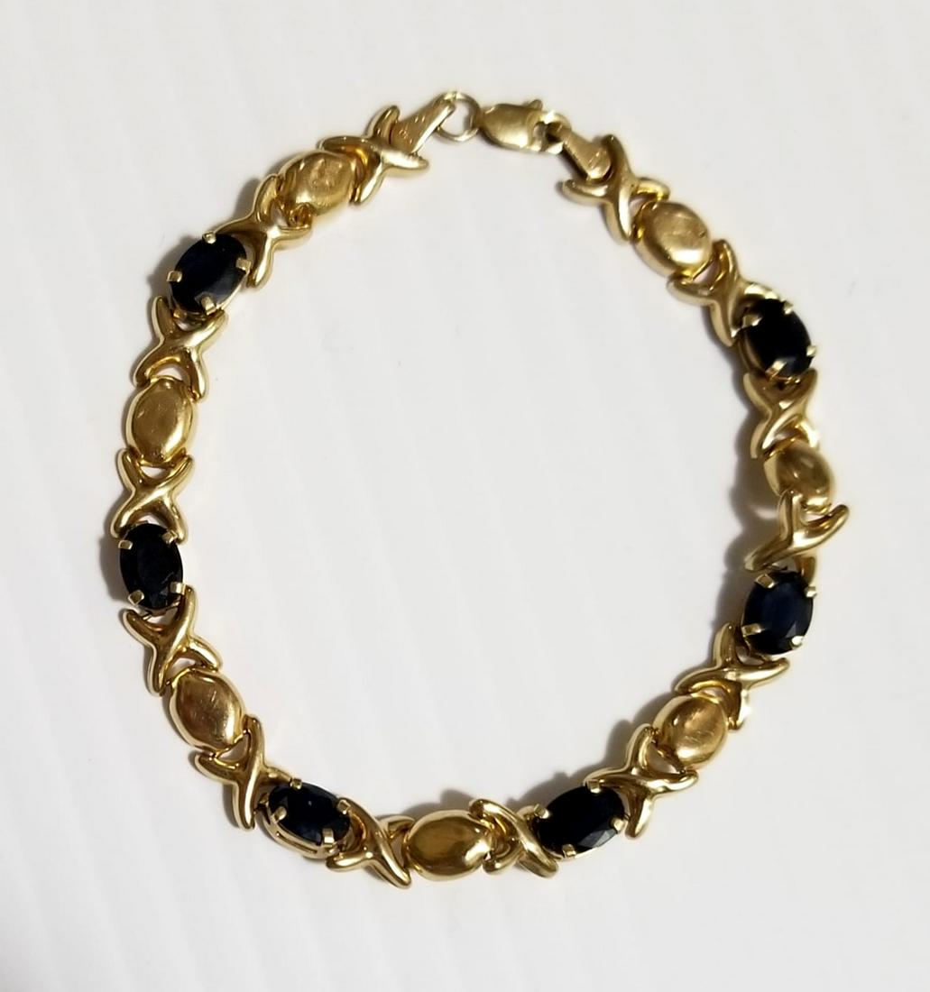 Nice CID 10 KT Articulate Blue Tanzanite Bracelet: Beautiful CID 10 KT Yellow gold articulate bracelet, blue Tanzanite 10 CT, 4.5 grams, 2.9 dwt, 7 1/8 x 1/4 inches long, 6 mm, it has 2 scratches, please refer to pictures.