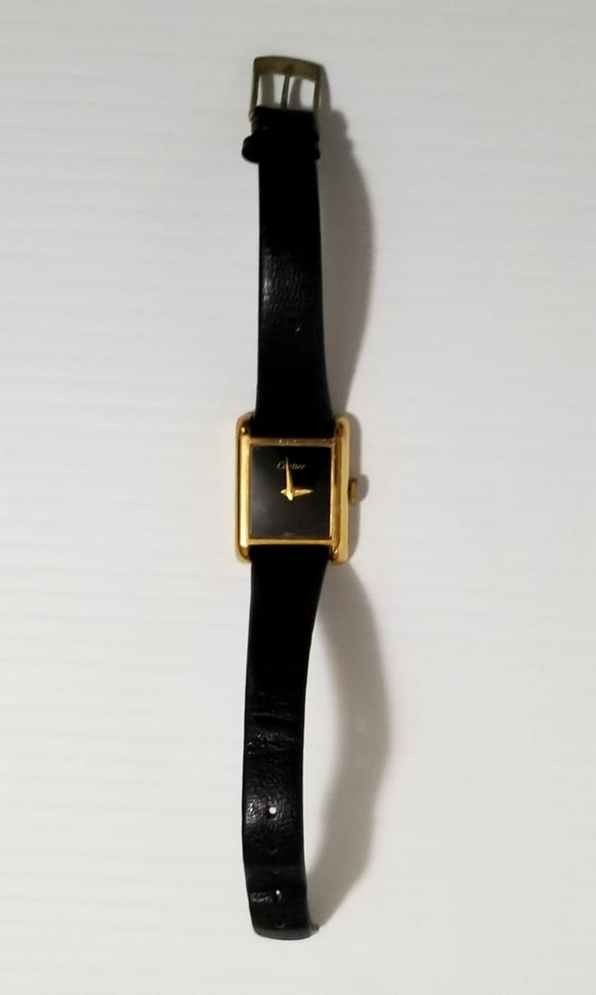 Amazing Cartier 18KT Electroplated Swiss Watch: Nice Cartier 18kt gold electroplated swiss watch, 10575, case 26 mm x 20 mm, black sphere, 17 jewels, works perfectly, black leather used, little scratches, loss of color on the crown, please refer to