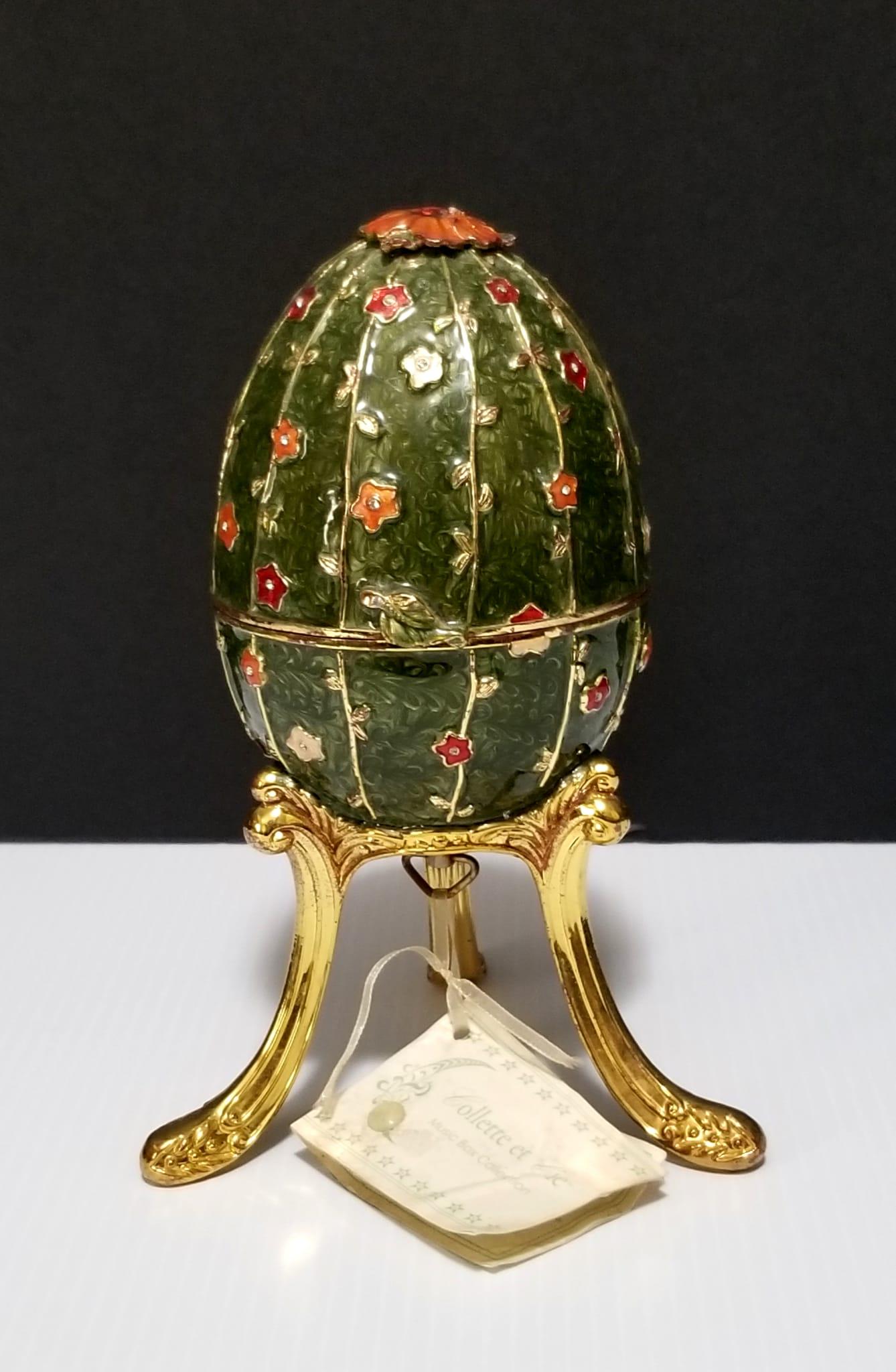Amazing Collette et Cie Enamel Egg Music Box: Beautiful Collette et Cie enamel flower egg music box, flowers and bids move, 7 3/4 x 3 1/2 inches round diameter. The golden part inside has some defect, please refer to photos for more details.