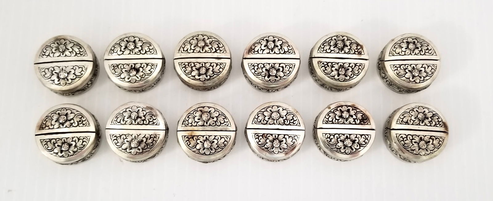 Amazing Cambodge 900 Sterling Silver 12 Piece Napkin Holders: Beautiful Cambodge 900 sterling silver 12 piece napkin holders, decorated flowers, 1 1/8 x 1/2 inches round approx.