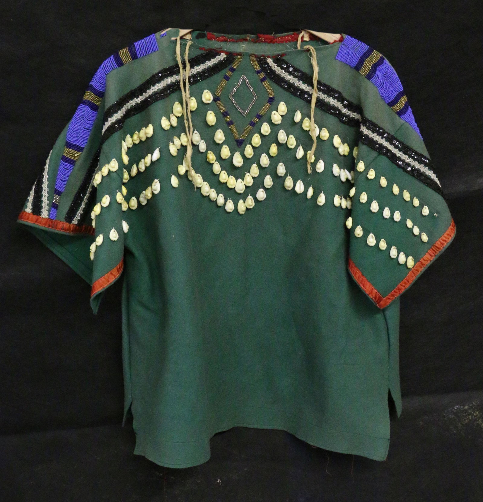 Plains Indian Woman's Shirt: Plains Indian Woman's Shirt with cowrie shell and beaded embellishments and silk ribbon trim, 26" long, twisted cordage.