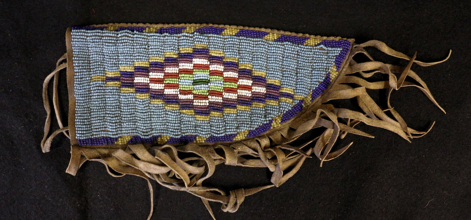 Indian Beaded Knife Sheath: Indian Beaded Knife Sheath with geometric designs and fringe, 9" long.