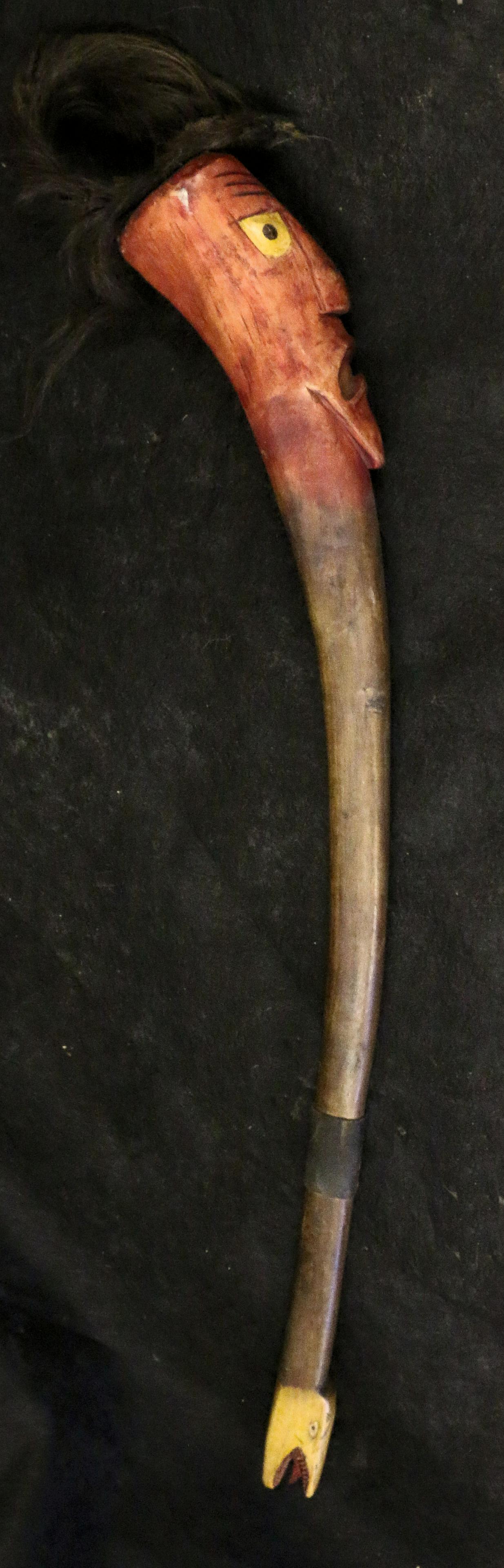 Wooden Club: Wooden Club with carved face and serpent motifs, 34" long.