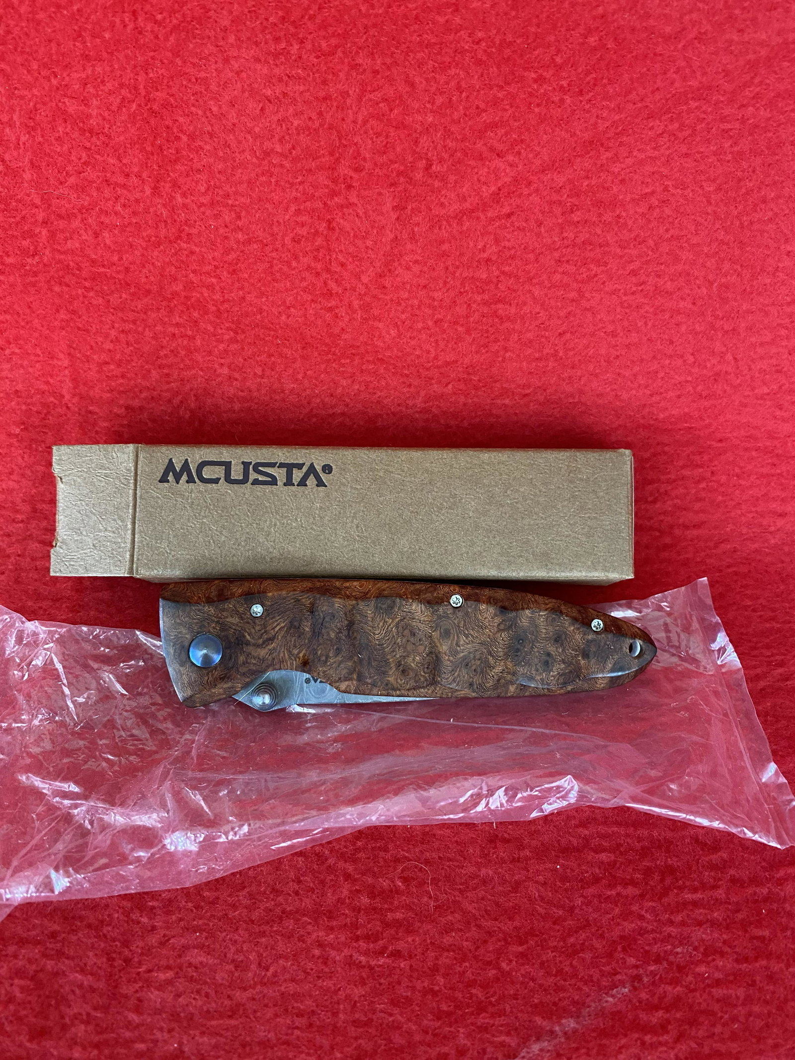 Hand Made Pocket Knife : by Mcusta Seki, Japan: Hand Made Pocket Knife : by Mcusta Seki, Japan, with Damascus blade and burl handles in unused condition with original box, Knife is 7.25" overall, 3.25" blade.