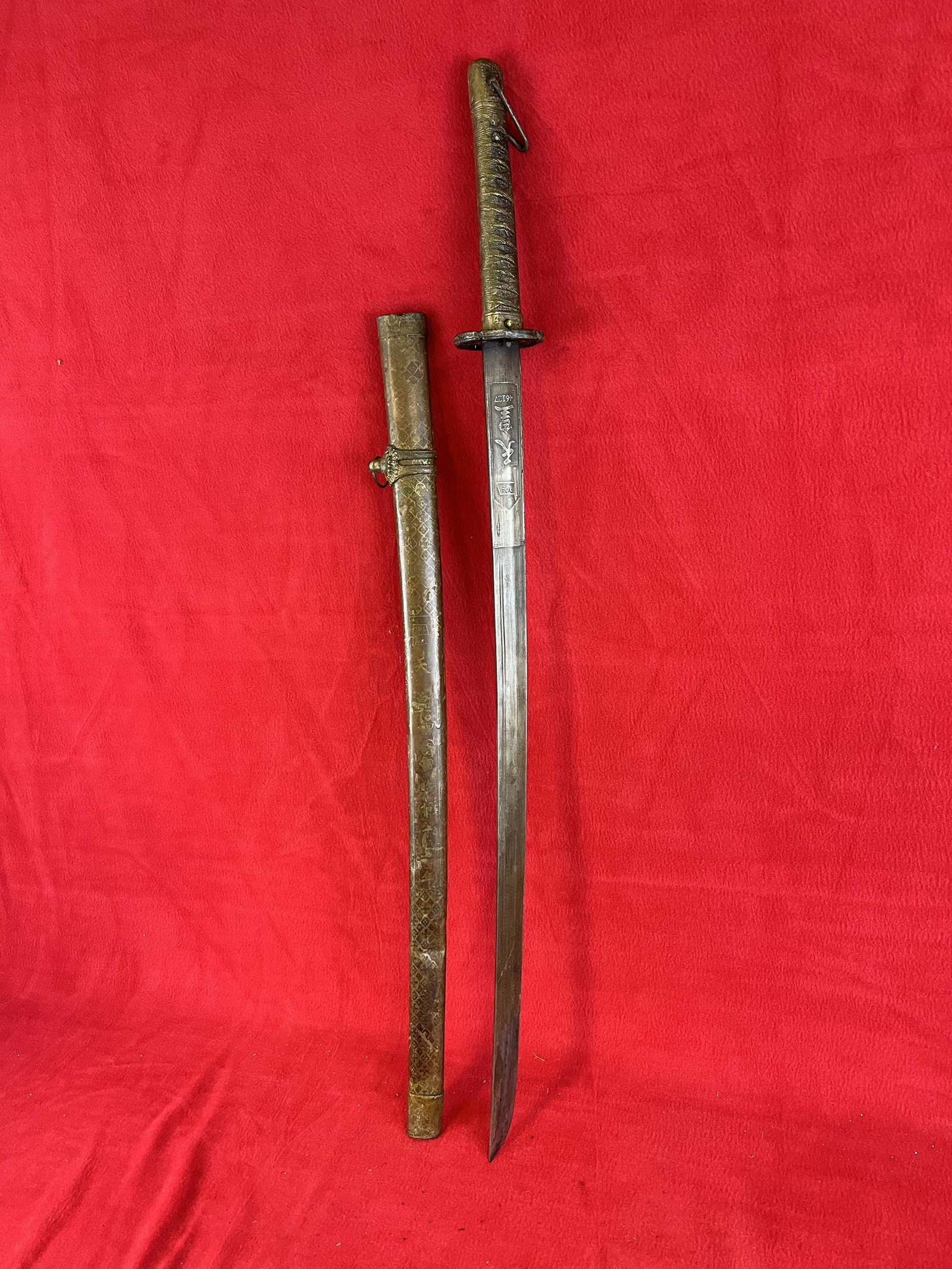 Vintage Samurai Sword: Vintage Samurai Sword which measures approximately 36" long with a 26 1/2" long blade. Scabbard is made of metal and has some denting as shown.