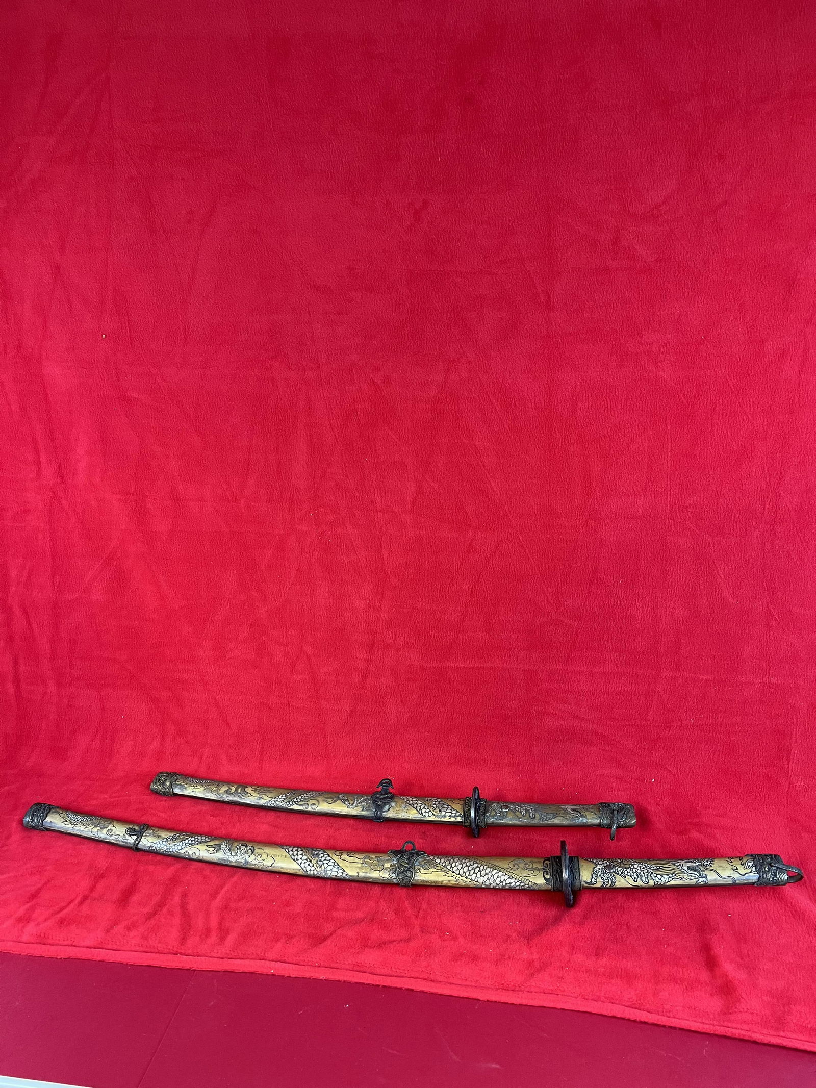 Matching Pair Of Japanese Samurai Swords: Matching Pair Of Japanese Samurai Swords including one with a 28 1/4" blade the other with a 18 1/2" blade. Both blades are signed in Japanese characters on the blade. Both swords have ornately decora