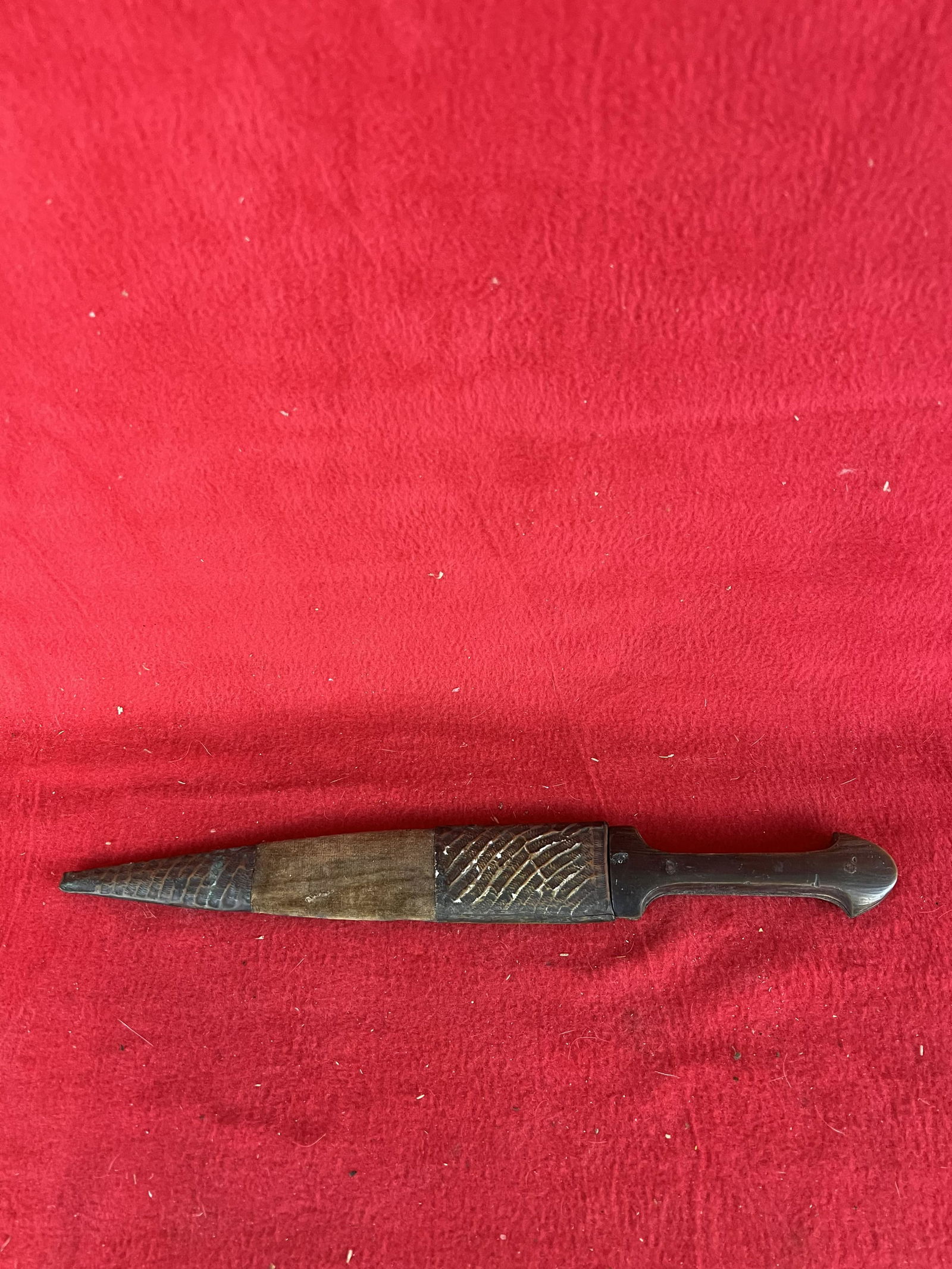 Turkish Dagger with Islamic Writing on Blade: Turkish Dagger with Islamic Writing on Blade in a brass and velvet covered wood sheath. Dagger has a horn handle and the overall measurement is 14". Blade has some wear and graying as shown.