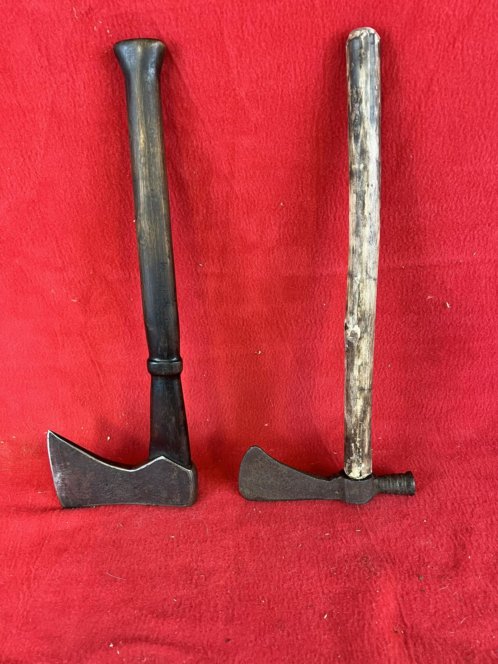Lot of Two Axes: Lot of Two Axes one having a carved wooden handle with iron head the other with a small tomahawk style head with a round wooden handle. The larger measures approximately 14 1/2" long. Condition - is a