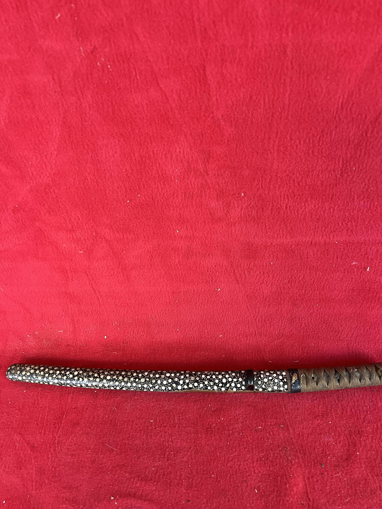 Antique Japanese Knife: Antique Japanese Knife in lacquer covered wooden sheath which measures approximately 19 1/4" in total length and with a 10 1/2" long blade. Sheath has some loss to covering as shown.