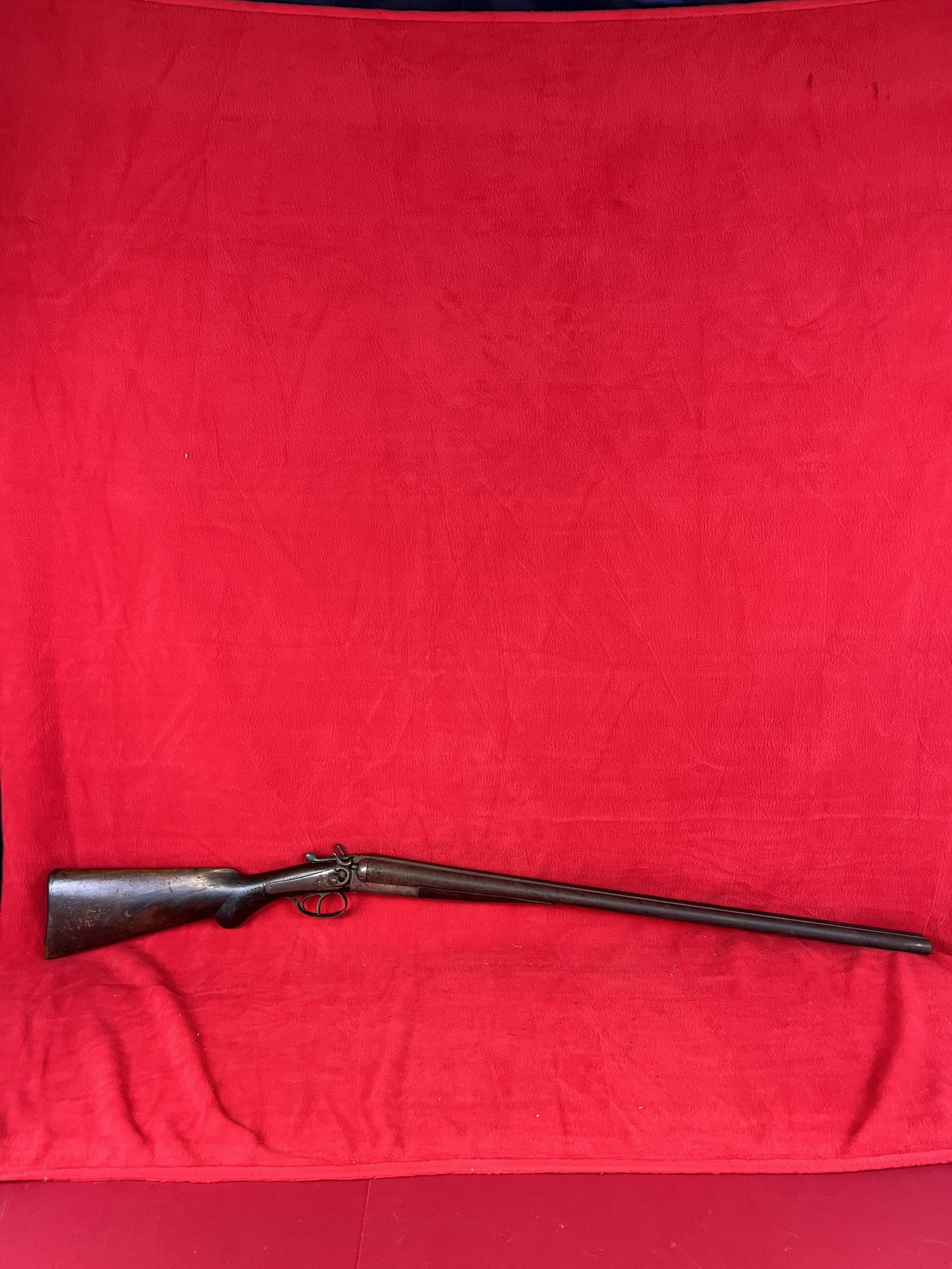 Double Barrel Percussion Shotgun marked Prize Machine: Patented June 30th 1883 Double Barrel Percussion Shotgun which is marked Prize Machine Gun on side of lock plate. The shotgun has a Damascus barrel and a walnut stock with engraved checkering on the f