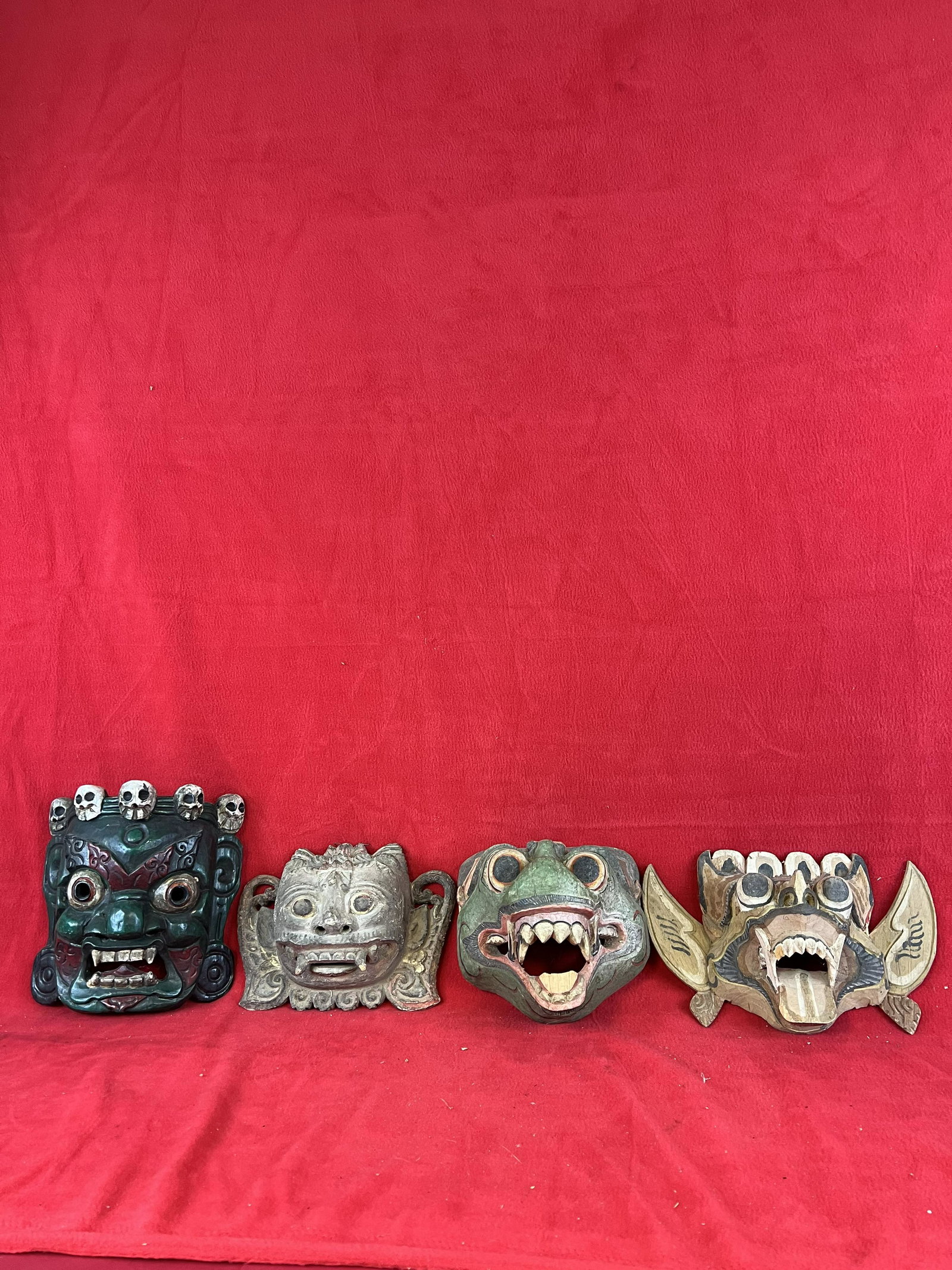 Lot of Four Hand Carved Japanese Wooden Masks: Lot of Four Hand Carved Japanese Wooden Masks which are painted in various colors. The largest mask in the lot measures approximately 9" tall. Condition - as shown with some chips and small losses.