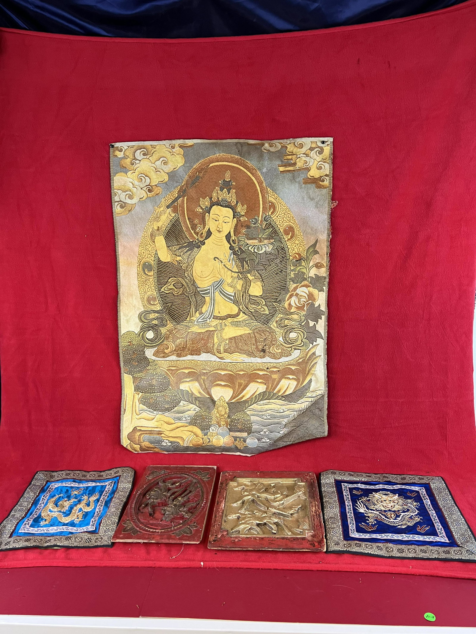 Lot of Asian Textiles and Wood Carved Panels: Lot of Asian Textiles and Wood Carved Panels. The larger carved panel measure approximately 12" by 10 1/2". Condition - textiles are fine, one of the wooden panels has been overpainted with modern gol