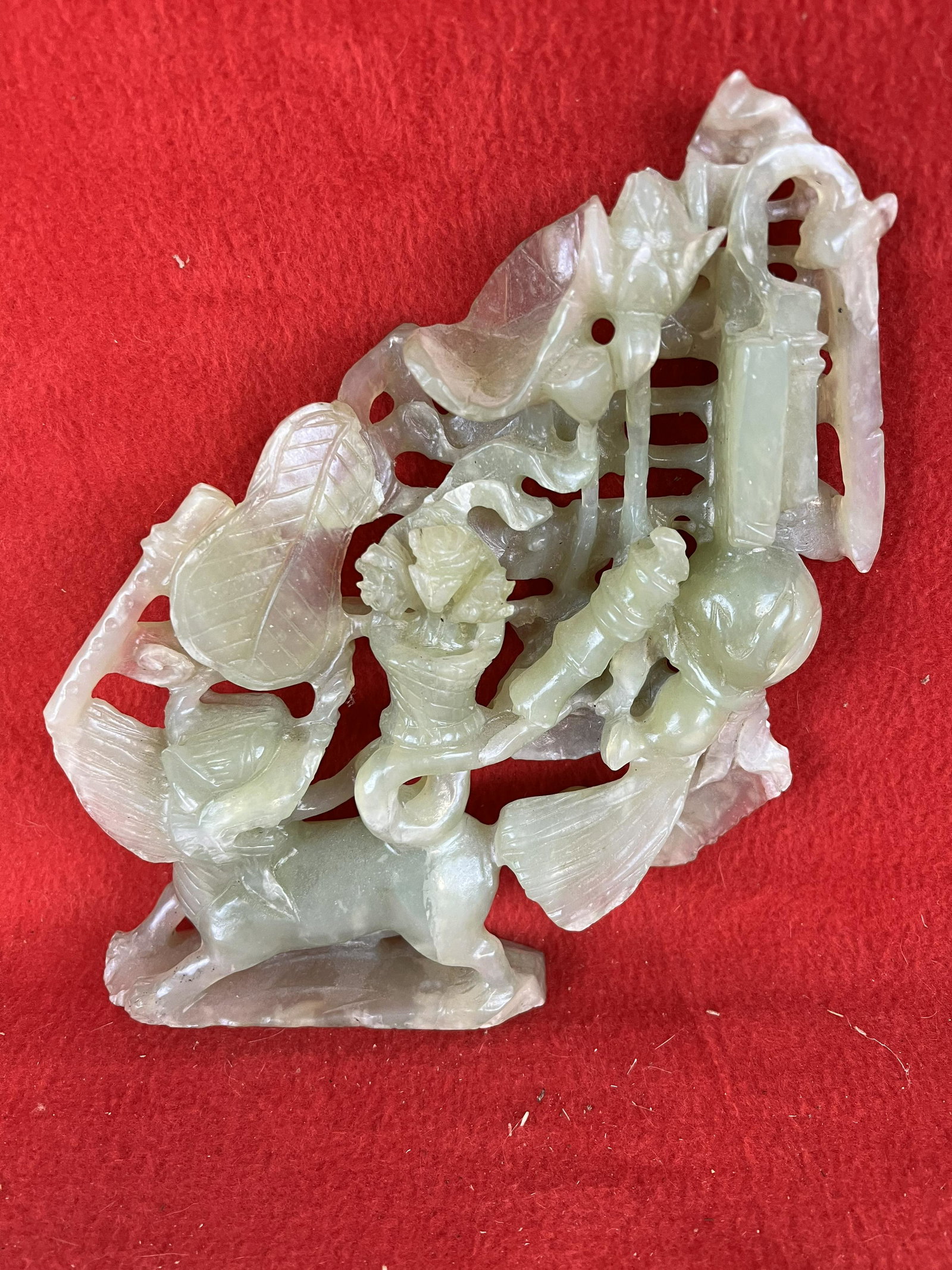 Vintage Asian Jade Carving: Vintage Asian Jade Carving with elaborate open work showing a foo dog, lotus blossoms etc. which measures approximately 8 1/2" tall and is 7 3/4" wide. Condition - is as shown.