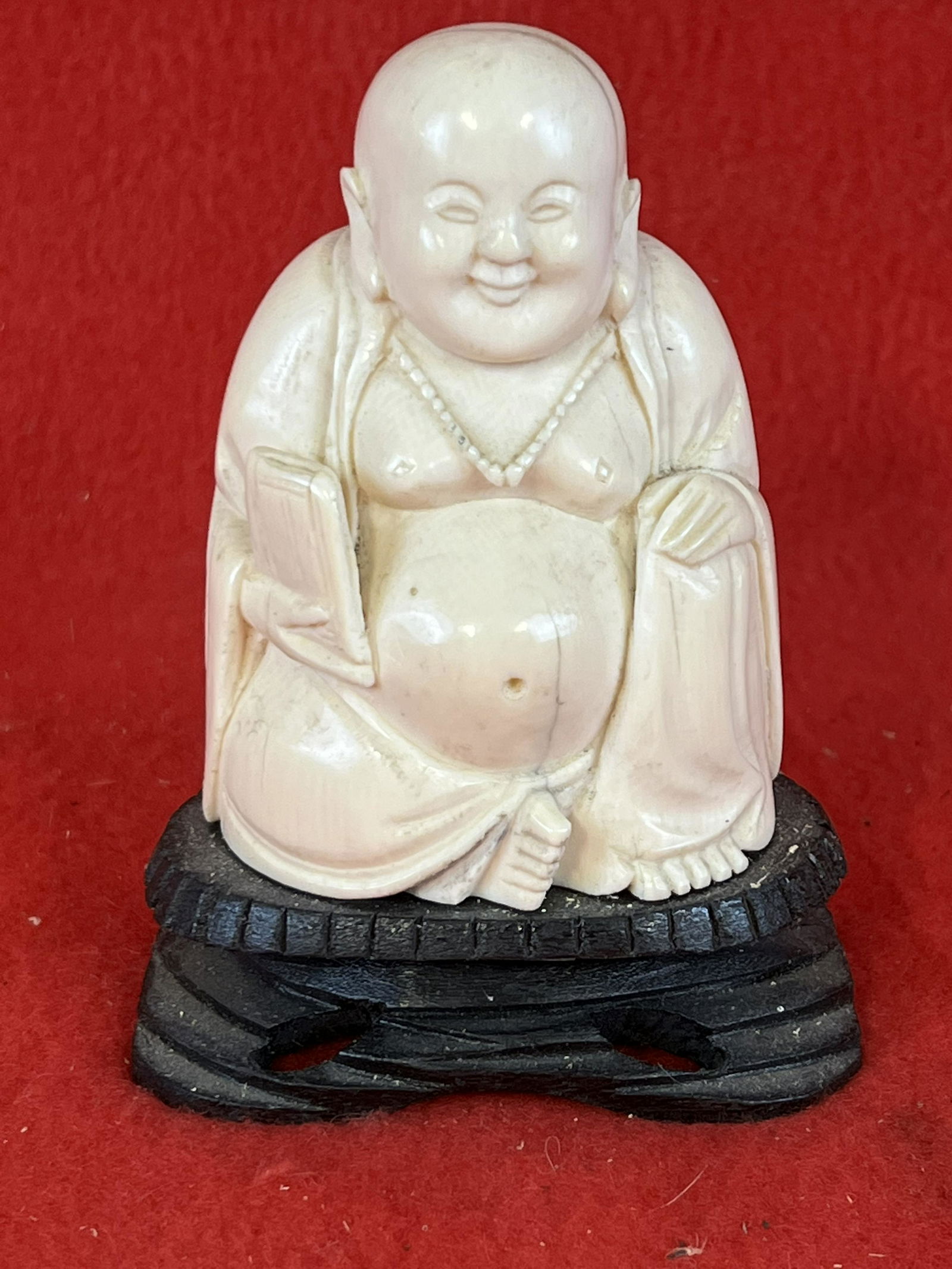 Vintage Chinese Carved Bone Figure of a Buddha: Vintage Chinese Carved Bone Figure of a Buddha which on its attached carved wooden base stands approximately 4 1/4" tall. Condition - fine just a couple naturally occurring shrinkage cracks from age b