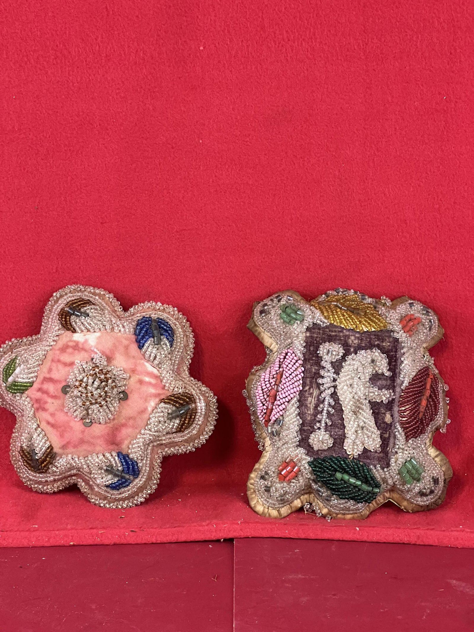Lot 2 Iroquois Niagara Falls Ware Pillows: A Lot Of Two Antique Glass Beaded Iroquois Niagara Falls Ware Pillows One Of Which Has A Depiction Of A Bird In Flight At Center. The Larger Pillow Measures Approximately 6 1/2" by 5 1/2". Condition -