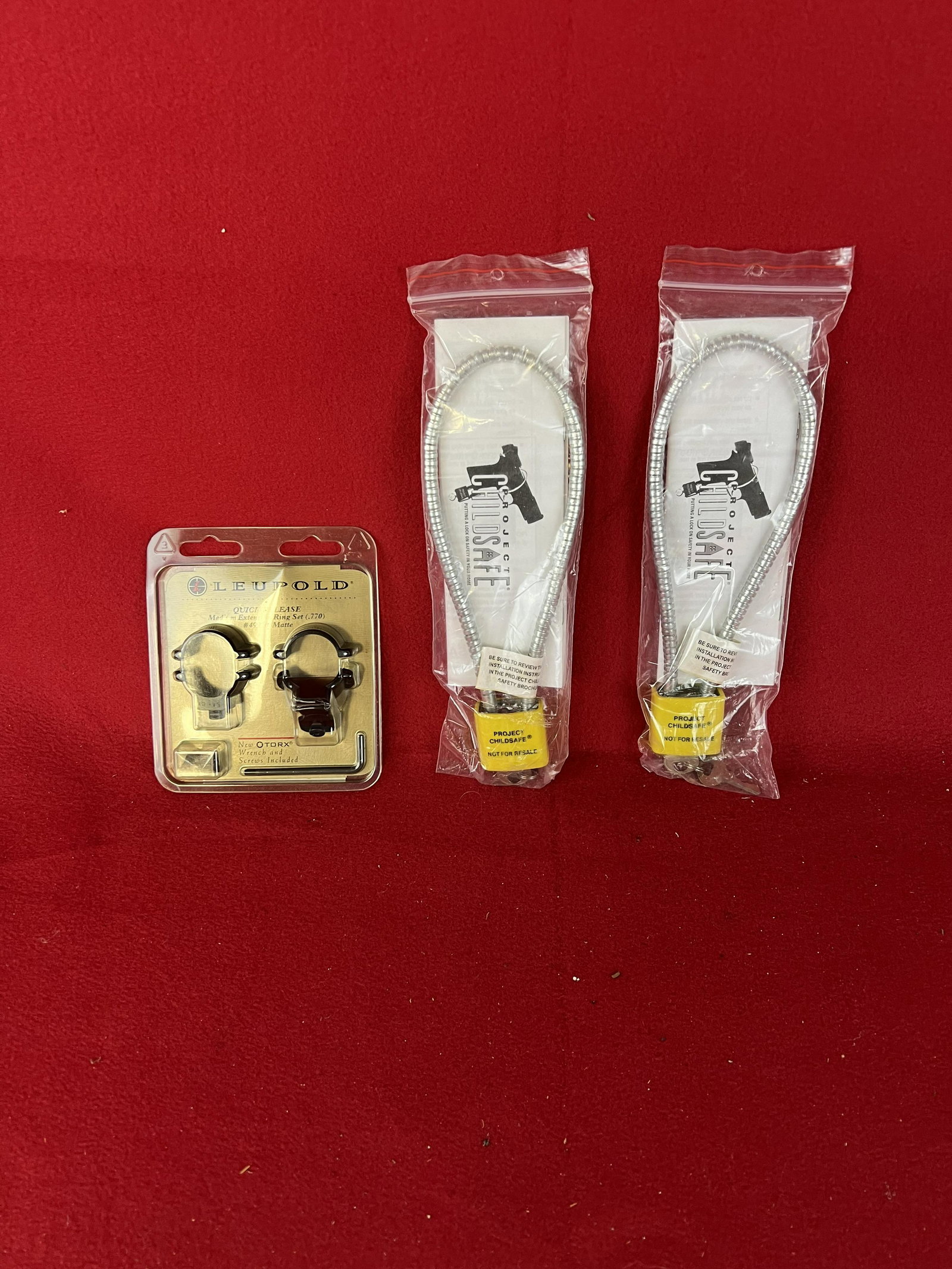 Lot: New Leupold Rifle Rings & 2 Gun Locks: Lot: New Leupold Rifle Rings & 2 Gun Locks In Original Packaging.