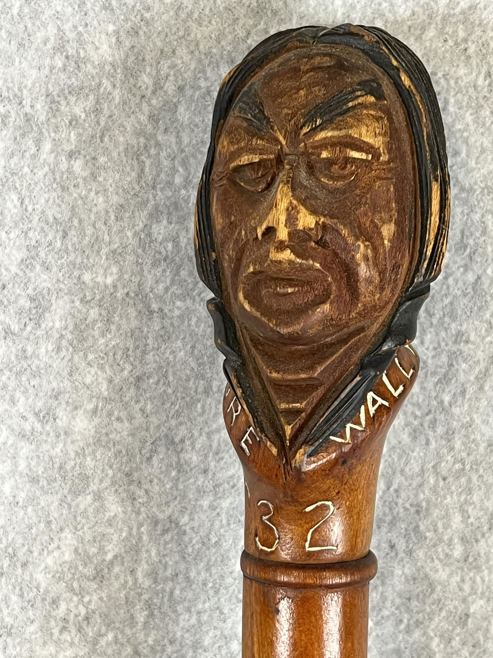Native American Carved 1932 Fraternity Graduation Cane: Vintage dated 1932 hand carved wooden cane done by a Penobscot Indian (Maine) which features a depiction of a Native American at the top and was done for a college fraternity. The cane has the names o