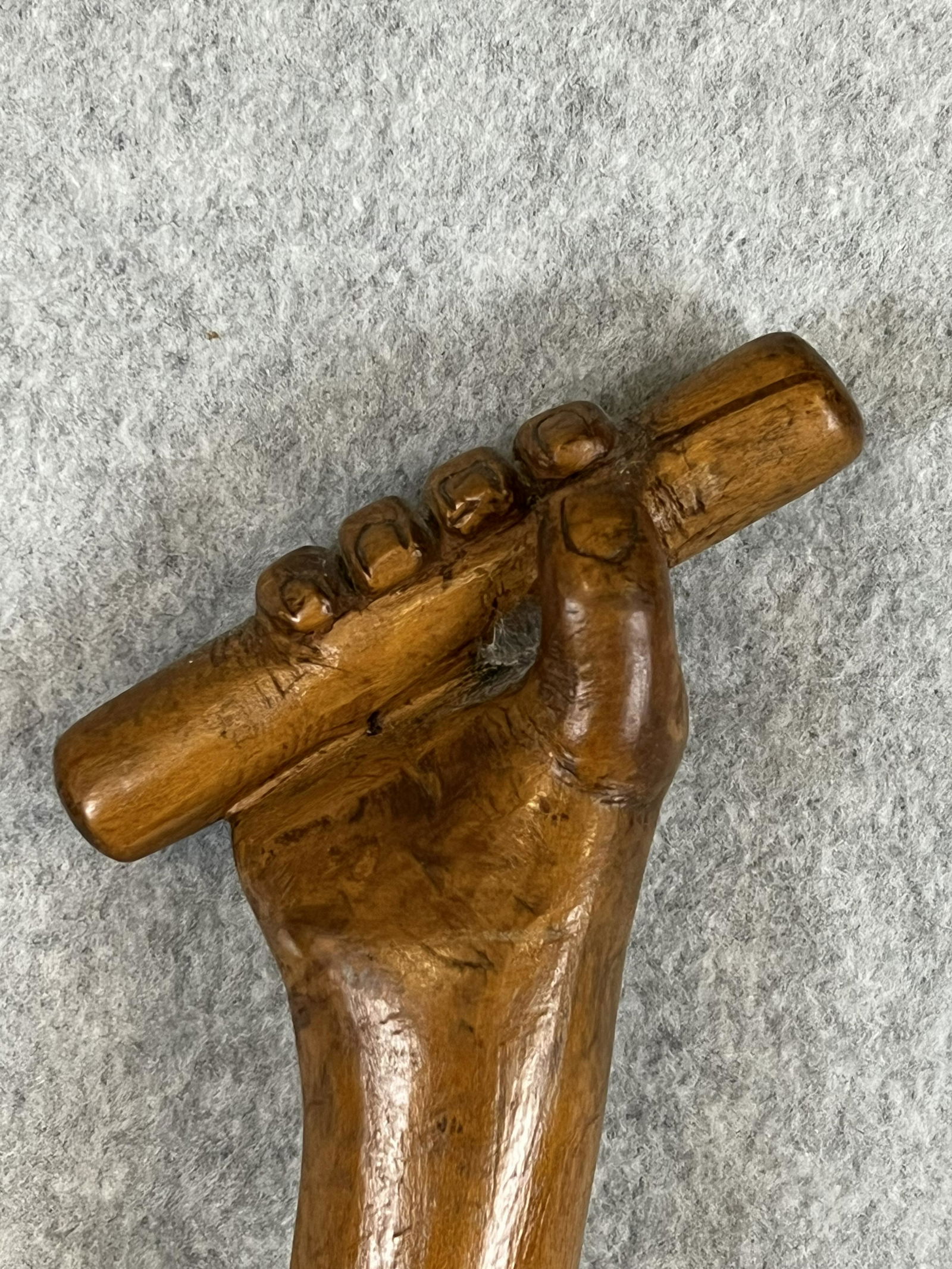 Antique Hand Carved Wooden Folk Art Cane With Hand: Antique hand carved wooden folk art cane / walking stick which features a human hand holding a stick and which measures approximately 37" tall. Cane is in fine condition.