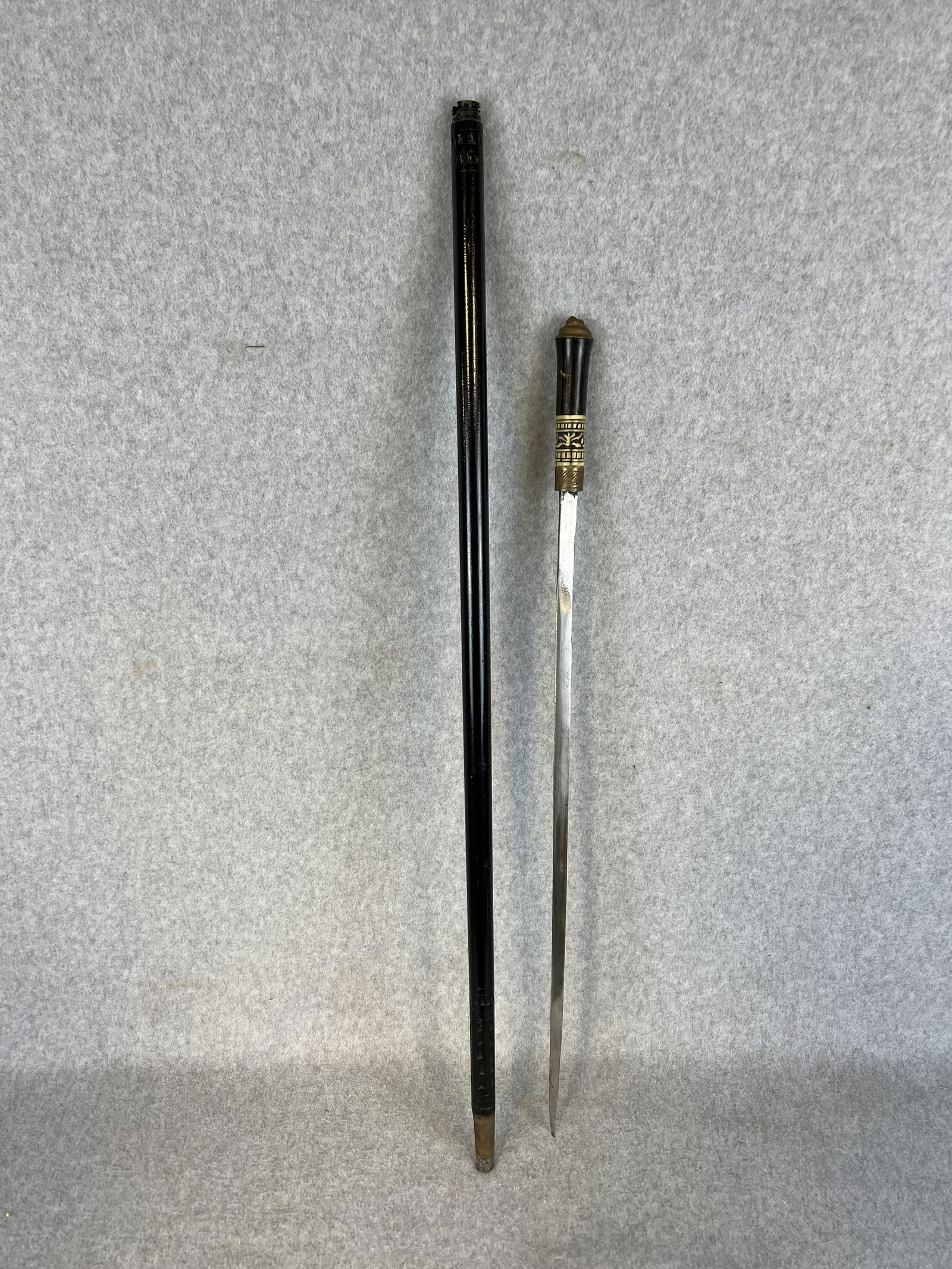 Antique Sword Cane With Horn, Bone & Brass Handle: Antique sword cane / walking stick which has a handle made of horn with a band of carved bone and having a brass top featuring the head of a lion and a ring of brass where top opens to reveal a steel