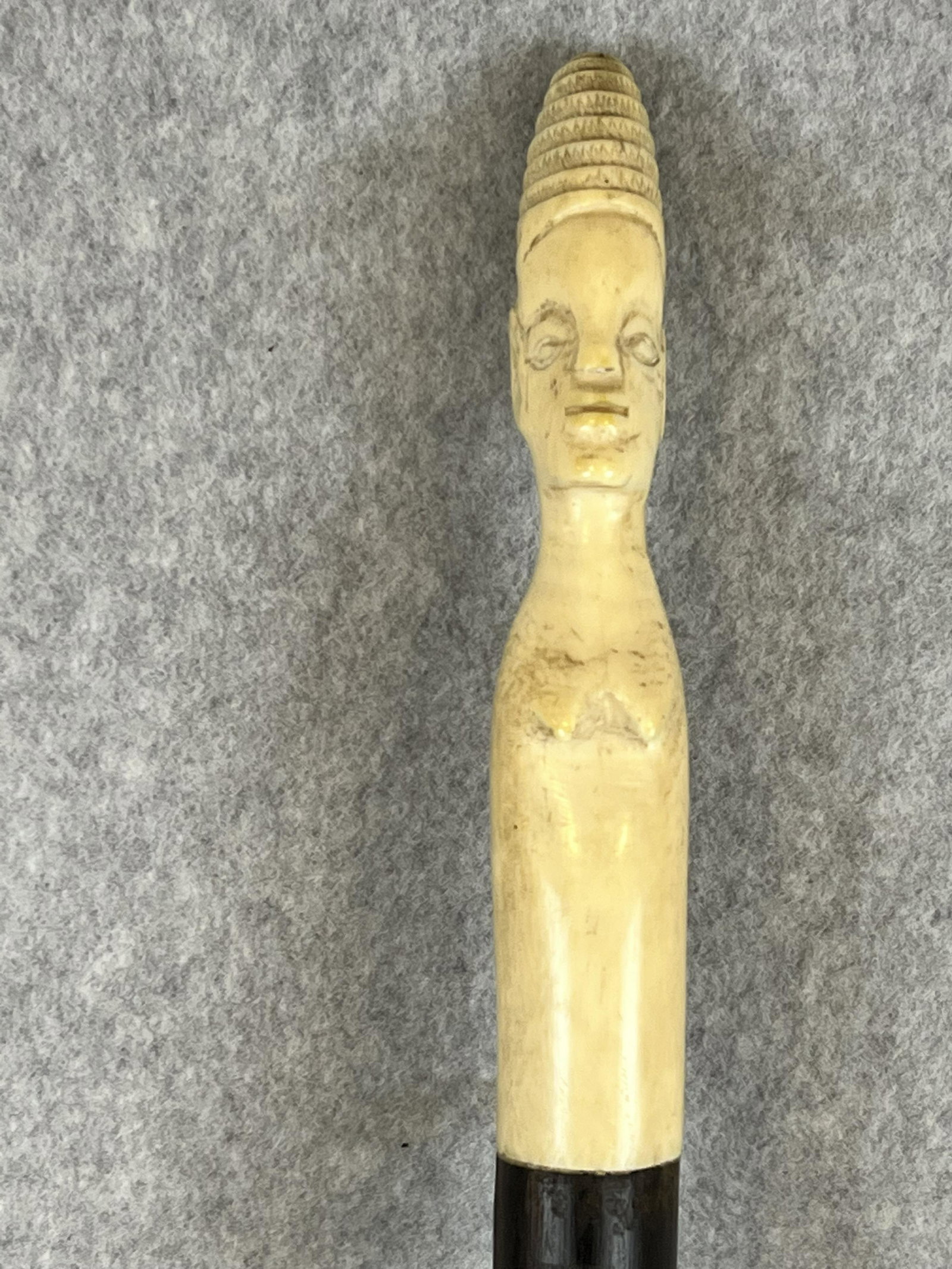 Antique African Carved Bone Headed Rosewood Cane: Antique African cane / walking stick with a hand carved 6" tall bone handle in the form of a woman on a rosewood shaft. Cane measures approximately 37" in overall length and is in fine condition.