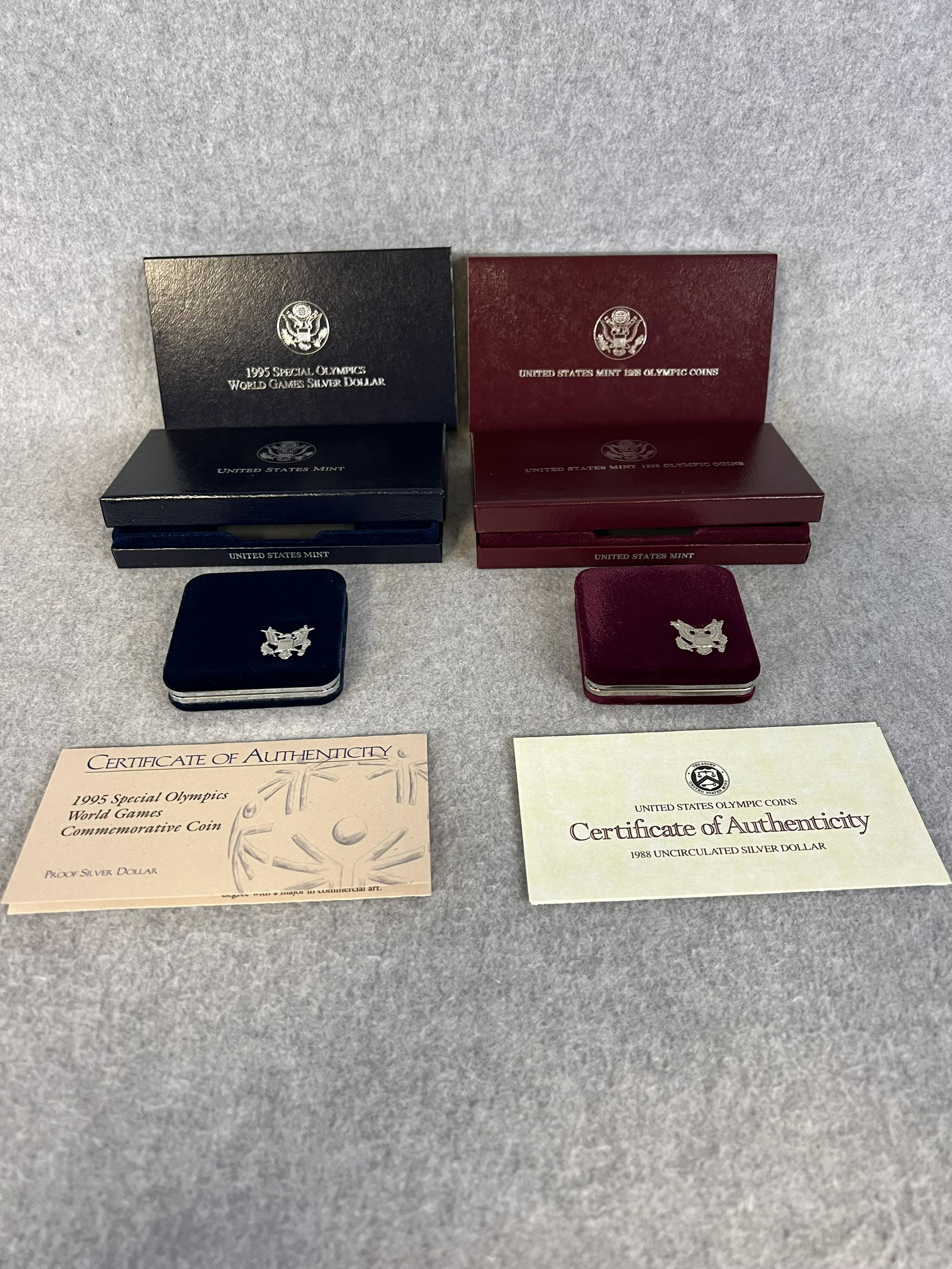 Lot 2 US Mint Coins ; 1995 Special Olympics & 1988 Olympic Coins w Box / COA: A lot of two US Mint coin sets ' 1995 Special Olympics World Games Silver Dollar and a 1988 Olympics Coins Set complete with boxes and COA's all in fine condition.