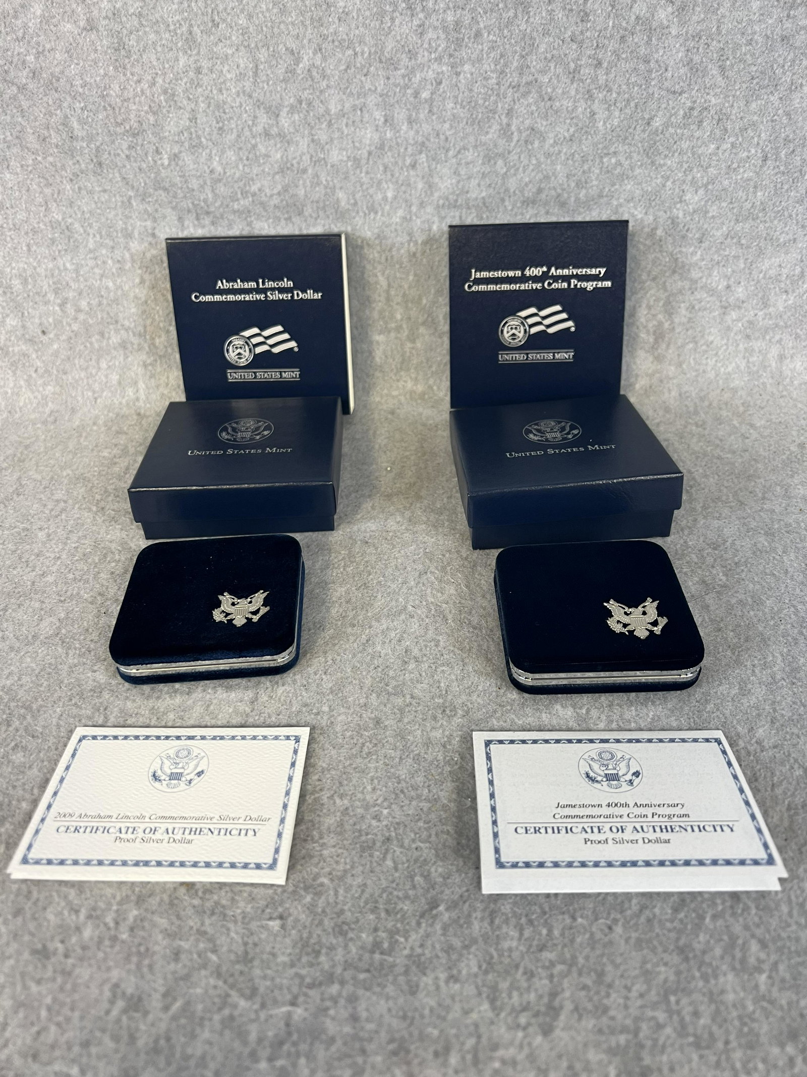 Lot 2 US Mint Commemorative Coin Program Proof Silver Dollars; 2007 Jamestown & Abe Lincoln: A lot of two US Mint commemorative coin program proof silver dollar coins to include a 2007 Jamestown 400th Anniversary and a 2009 Abraham Lincoln complete with boxes and COA's all in fine condition.