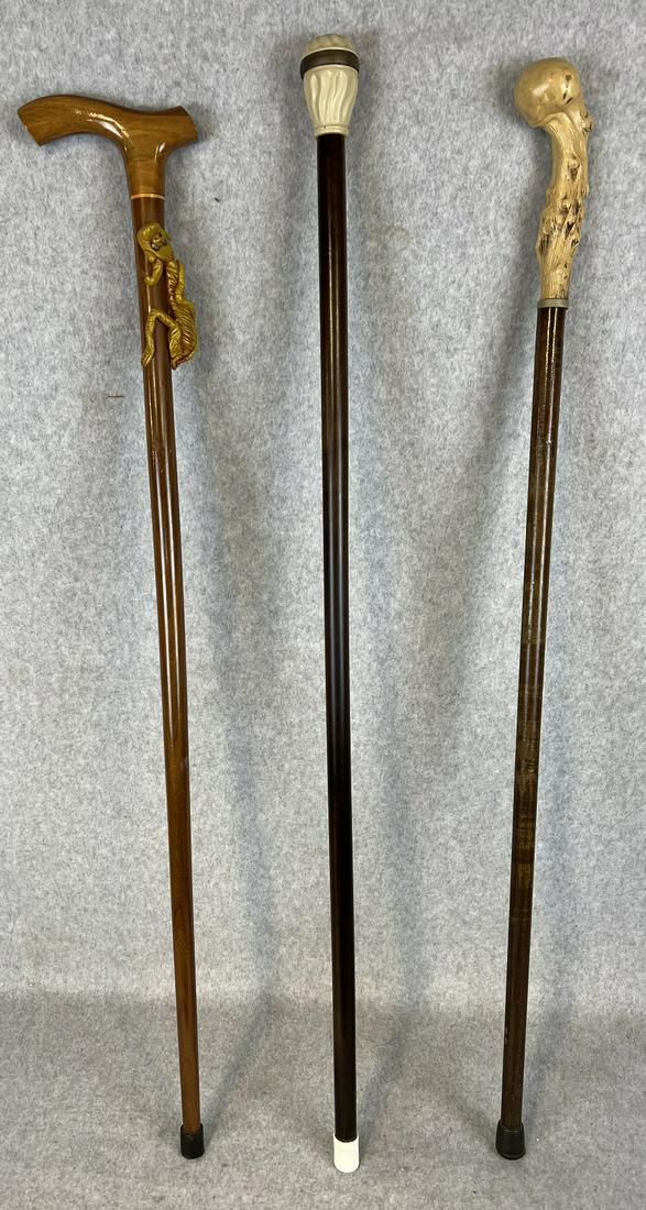 Lot 3 Canes Including A sundial Cane: Lot Of Three canes / walking sticks to include one with a resin cast sundial top on a wooden shaft (the screw on top is loose and will not fully engage the threads on the bottom, another with a resin