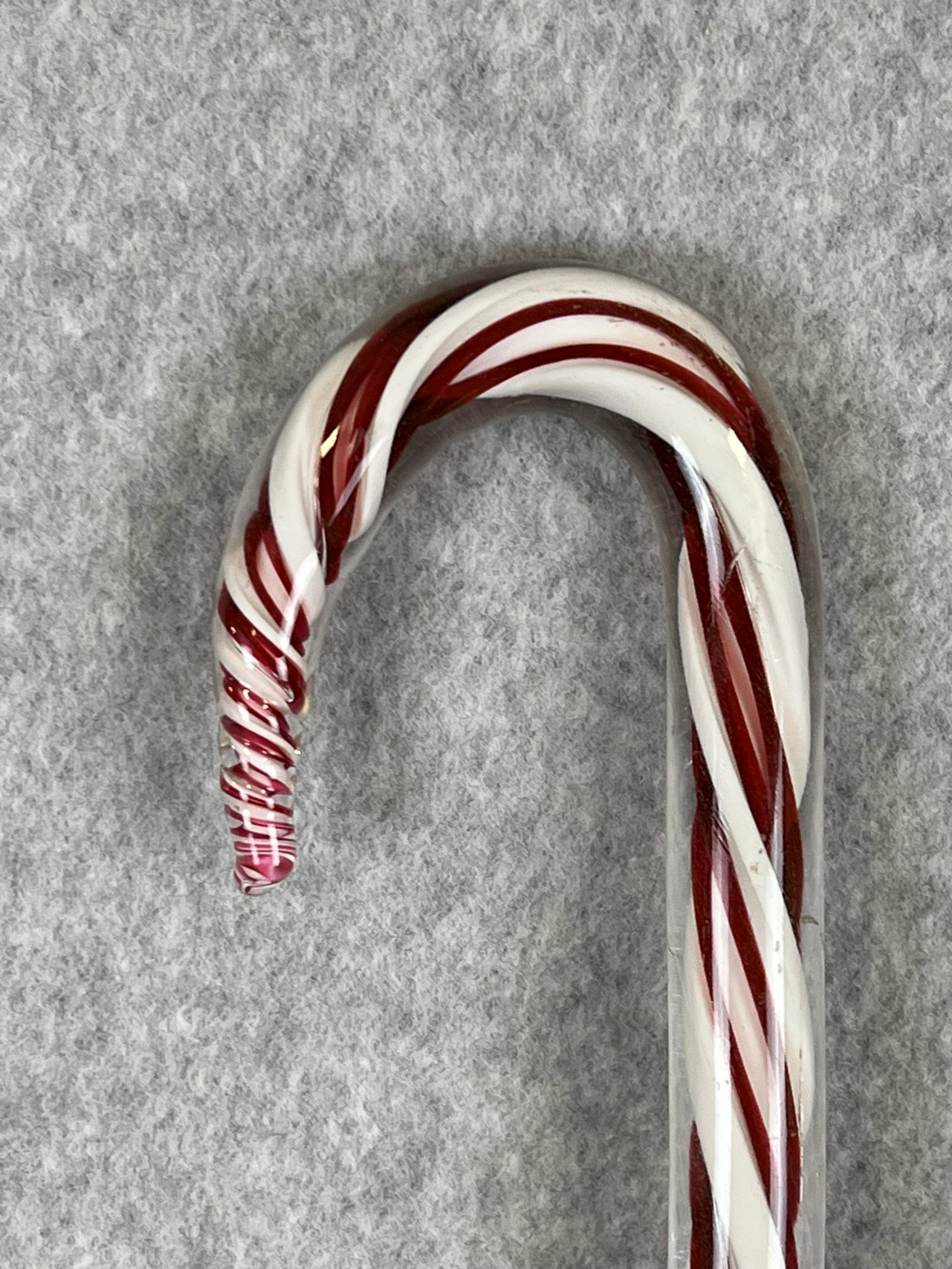 Antique Blown Glass Cane With Red And White Candy Stripe Swirls: Antique solid blown clear glass cane containing red and white candy stripe swirls. The cane measures approximately 34" tall with some chipping at the tip otherwise fine.