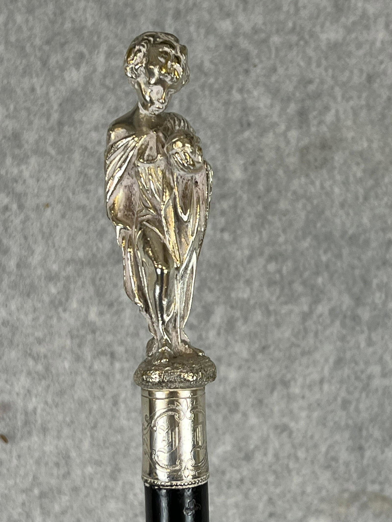 Exceptional Antique Boy Holding orb Silver Headed Cane: Exceptional antique cane with a unmarked but appears to be heavy solid silver handle in the form of a young boy holding a orb in his hand. The silver head measures approximately 4 1/4" tall and there