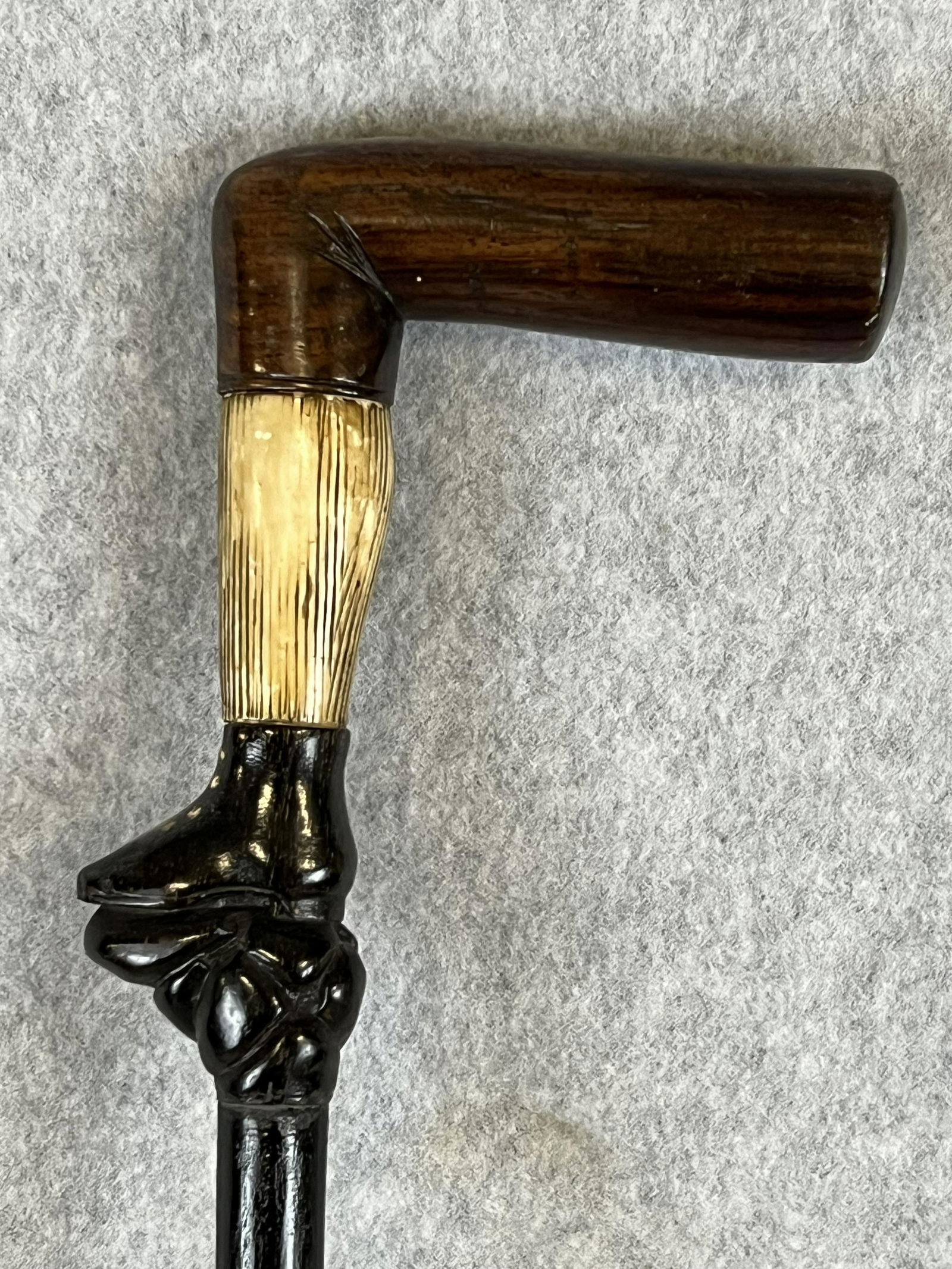 Antique Cane With Leg & Shoe Figural Handle: Antique cane / walking stick which has a hand carved handle in the form of a leg wearing a boot or shoe. The top of the handle representing a upper leg is made from rosewood with the calf or lower leg