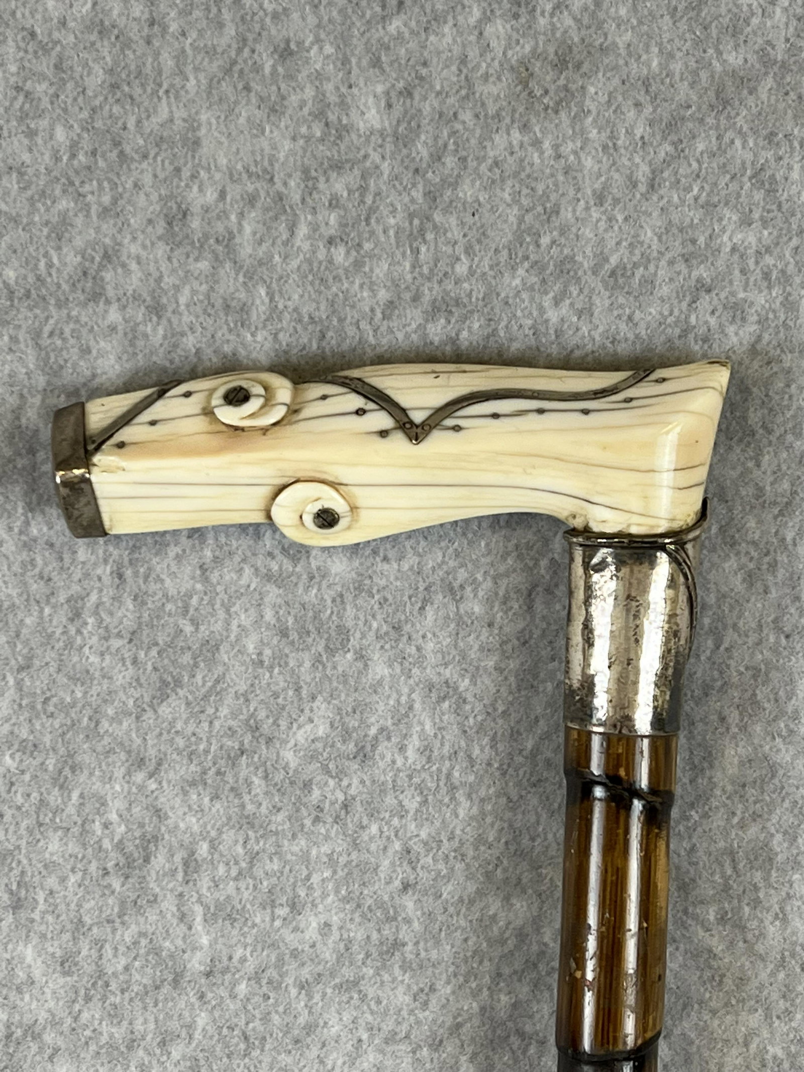Antique Silver Mounted Carved Bone Handled Cane / Walking Stick: Antique silver mounted carved bone handled cane / walking stick with a marked sterling silver collar mounted on a bamboo shaft with a metal ferrule. Cane measures approximately 34" long and is in fine