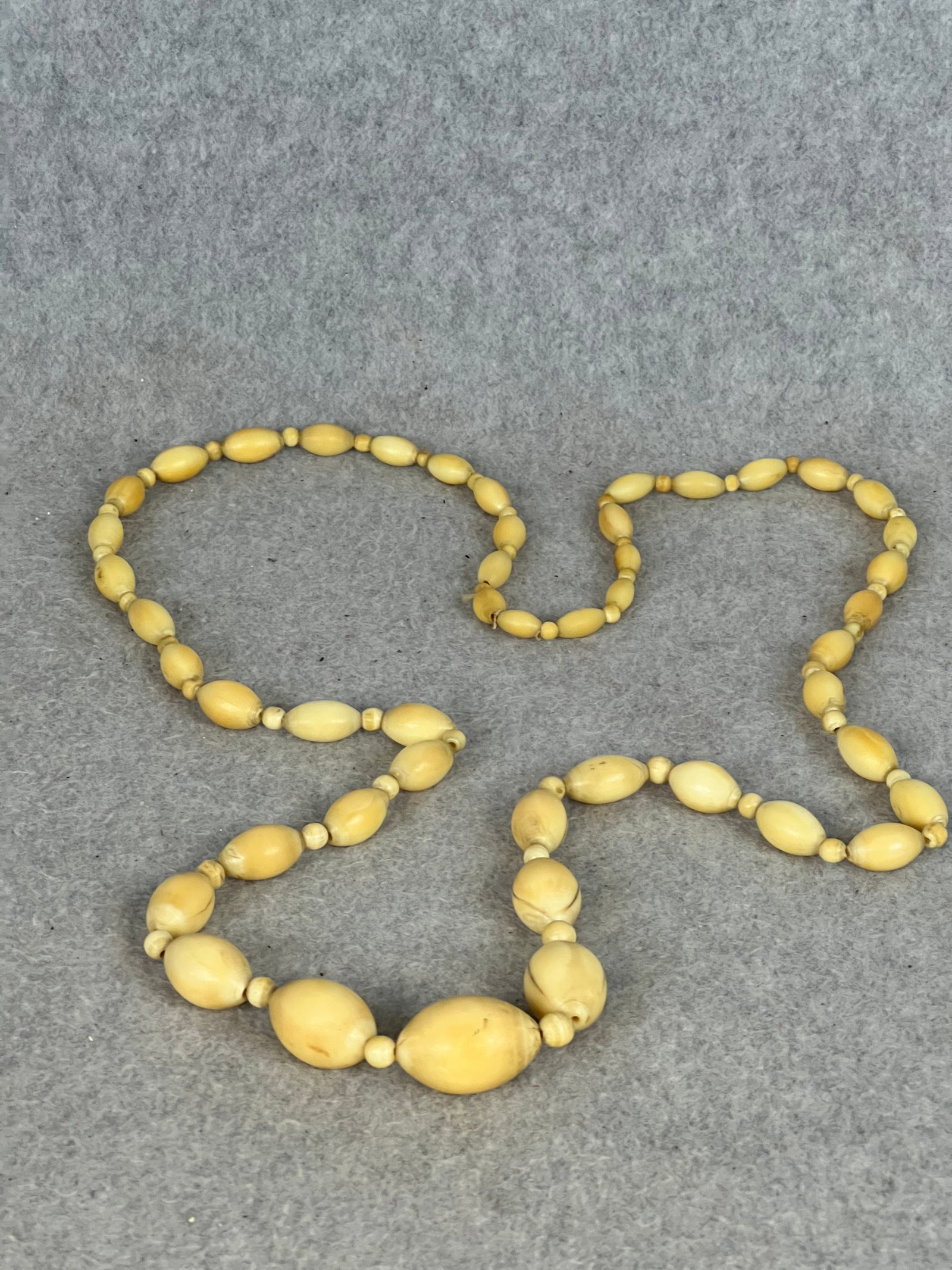 Antique 19th C Carved Bone Necklace: Antique 19th century carved bone necklace which measures approximately 40" long with the largest bead being approximately 1 1/8" wide and 3/4" tall. Condition - excellent with a fine all original pati
