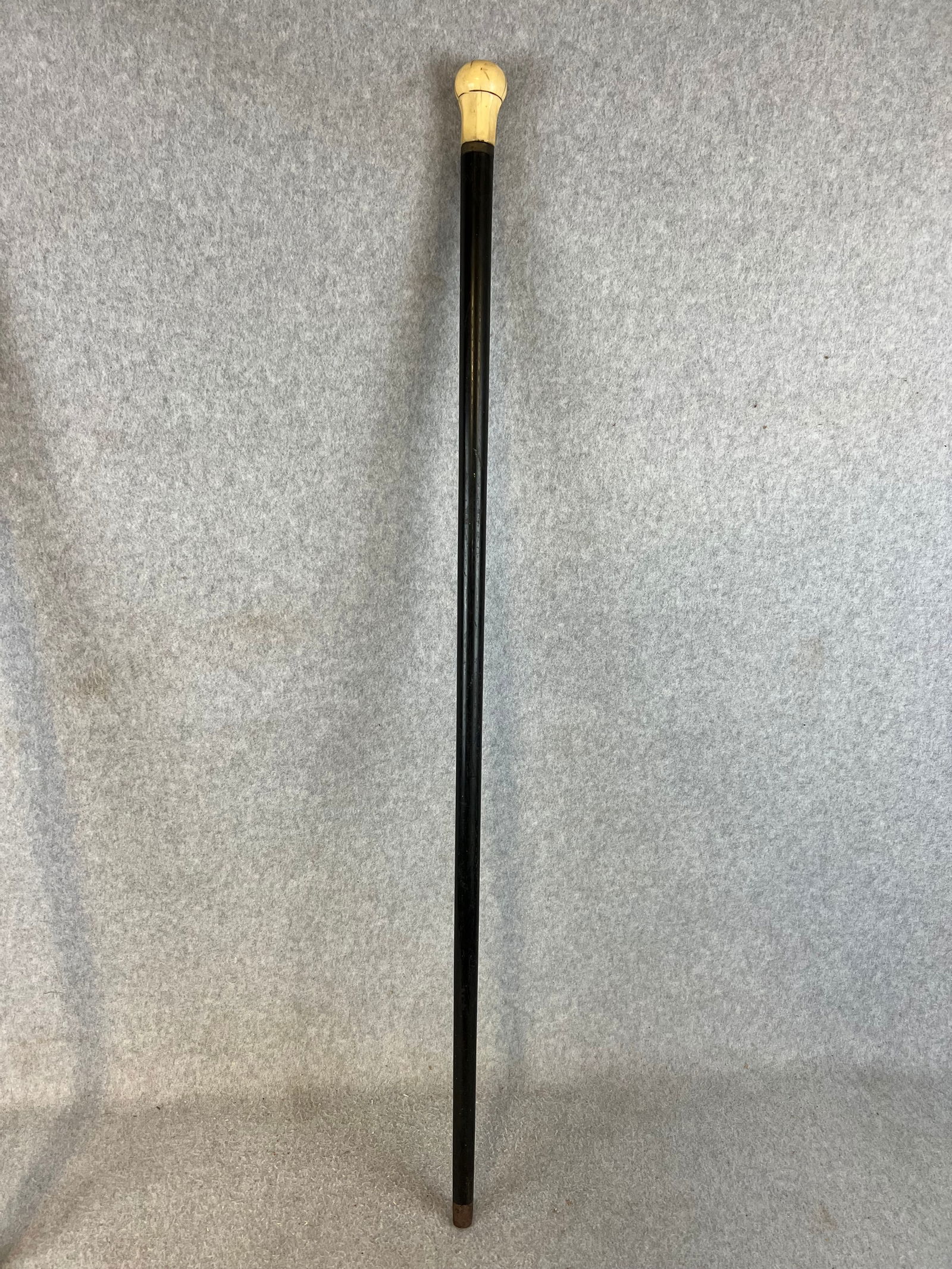 Bone Handled Victorian Walking Stick / Cane: Bone handled Victorian walking stick/cane. Shaft is made of ebony with a German silver ferrule and having a iron tip. Cane measures approximately 36" long. Condition - some age cracking to the top as