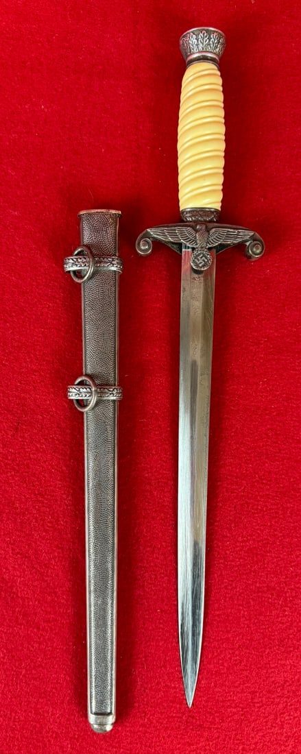 WW2 German Army Officer Dress Dagger By Karl Eickhorn: World War Two Nazi German Army Officer's Dress Dagger by Karl Eickhorn (Squirrel mark). Dagger has a white ivorine handle and the correct dagger sheath all in very nice condition with just some minor 