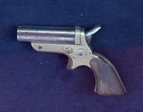 1859 Sharps 4 Shot Pepperbox Pistol: 1859 Patent Sharps four shot pepperbox pistol with brass frame and steel barrels. Pistol is nicely presented in a period walnut shadow box frame. Condition - some pitting to the steel barrels as shown