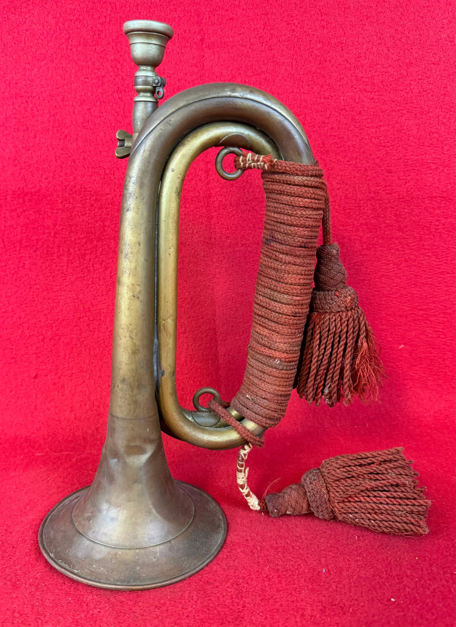 Civil War Copper & Brass Bugle: Civil War unmarked copper and brass double twist bugle with reinforced bell and having a period attached red artillery cord with tassels. Bugle measures approximately 11 1/2" long with a 4 1/2" diamet