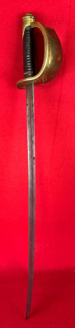 Ames M1860 Naval Cutlass Dated 1861: M1860 Naval cutlass made by the Ames Manufacturing Company Chicopee Massachusetts which is dated 1861 on one side of the tang and with the Ames mark on the other. Cutlass has a brass guard and a black